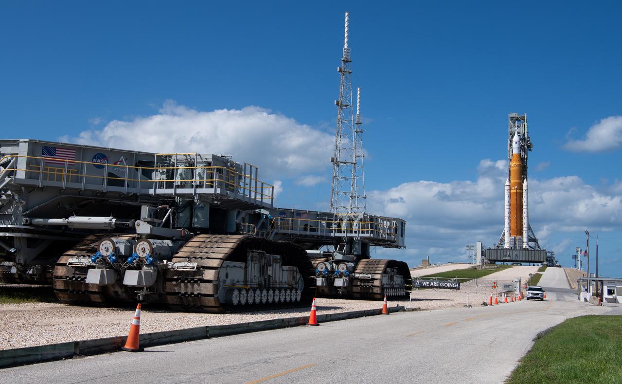 Crawler Transporter-2 (CT-2) is seen outside the gates at Launch Pad 39B as teams configure systems for rolling NASA’s Space Launch System (SLS) rocket and Orion spacecraft back to the Vehicle Assembly Building, Saturday, Sept. 24, 2022, at NASA’s Kennedy Space Center in Florida. NASA is foregoing a launch opportunity on Tues. Sept. 27 and continues to watch the weather forecast associated with Tropical Storm Ian. The NASA’s Artemis I flight test is the first integrated test of the agency’s deep space exploration systems: the Orion spacecraft, SLS rocket, and supporting ground systems.  Photo Credit: (NASA/Joel Kowsky)