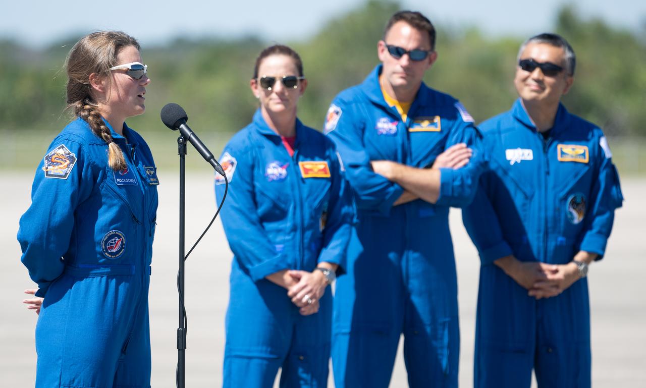 Roscosmos cosmonaut Anna Kikina, left, speaks to members of the media after arriving at the Launch and Landing Facility with fellow crew members NASA astronaut Nicole Mann, second from left, NASA astronaut Josh Cassada, second from right, and Japan Aerospace Exploration Agency (JAXA) astronaut Koichi Wakata, right, at NASA’s Kennedy Space Center ahead of SpaceX’s Crew-5 mission, Saturday, Oct. 1, 2022, in Florida. NASA’s SpaceX Crew-5 mission is the fifth crew rotation mission of the SpaceX Crew Dragon spacecraft and Falcon 9 rocket to the International Space Station as part of the agency’s Commercial Crew Program. Mann, Cassada, Wakata, and Kikini are scheduled to launch at 12:00 p.m. EDT on Oct. 5, from Launch Complex 39A at the Kennedy Space Center. Photo Credit: (NASA/Joel Kowsky)