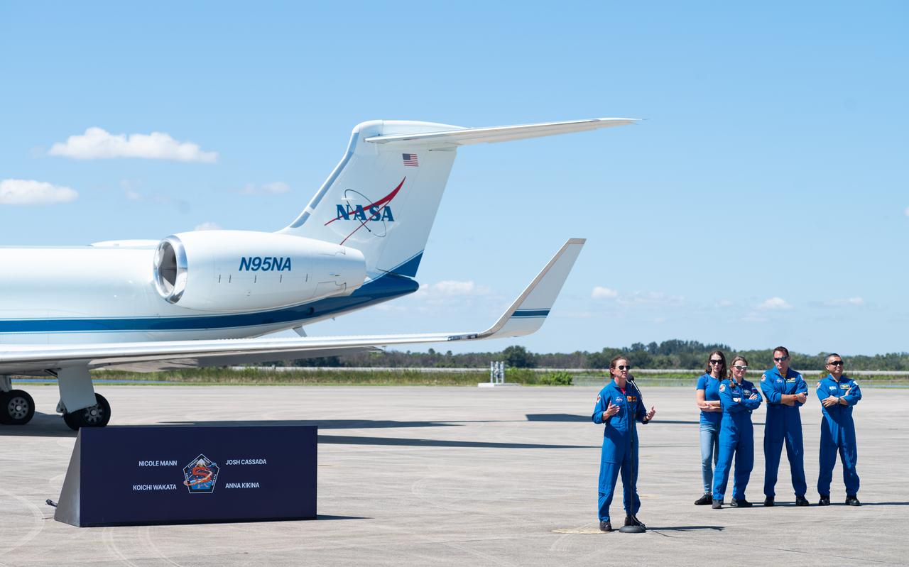 NASA astronaut Nicole Mann, left, speaks to members of the media after arriving at the Launch and Landing Facility with fellow crew members Roscosmos cosmonaut Anna Kikina, second from left, NASA astronaut Josh Cassada, second from right, and Japan Aerospace Exploration Agency (JAXA) astronaut Koichi Wakata, right, at NASA’s Kennedy Space Center ahead of SpaceX’s Crew-5 mission, Saturday, Oct. 1, 2022, in Florida. NASA’s SpaceX Crew-5 mission is the fifth crew rotation mission of the SpaceX Crew Dragon spacecraft and Falcon 9 rocket to the International Space Station as part of the agency’s Commercial Crew Program. Mann, Cassada, Wakata, and Kikini are scheduled to launch at 12:00 p.m. EDT on Oct. 5, from Launch Complex 39A at the Kennedy Space Center. Photo Credit: (NASA/Joel Kowsky)