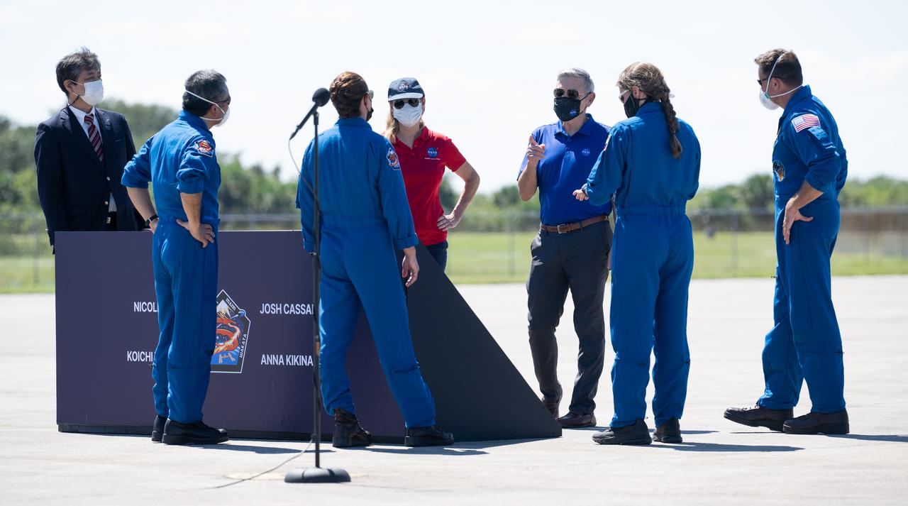 Junichi Sakai, manager of the International Space Station Program for the Japan Aerospace Exploration Agency (JAXA), Kennedy Space Center director Janet Petro, and Bob Cabana, NASA associate administrator, speak with NASA astronauts Nicole Mann and Josh Cassada, Japan Aerospace Exploration Agency (JAXA) astronaut Koichi Wakata, and Roscosmos cosmonaut Anna Kikina, after their arrival at the Launch and Landing Facility at NASA’s Kennedy Space Center ahead of SpaceX’s Crew-5 mission, Saturday, Oct. 1, 2022, in Florida. NASA’s SpaceX Crew-5 mission is the fifth crew rotation mission of the SpaceX Crew Dragon spacecraft and Falcon 9 rocket to the International Space Station as part of the agency’s Commercial Crew Program. Mann, Cassada, Wakata, and Kikini are scheduled to launch at 12:00 p.m. EDT on Oct. 5, from Launch Complex 39A at the Kennedy Space Center. Photo Credit: (NASA/Joel Kowsky)