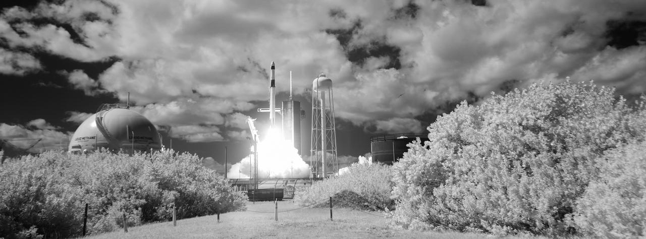 In this black and white infrared image, a SpaceX Falcon 9 rocket carrying the company's Crew Dragon spacecraft is launched on NASA’s SpaceX Crew-5 mission to the International Space Station with NASA astronauts Nicole Mann and Josh Cassada, Japan Aerospace Exploration Agency (JAXA) astronaut Koichi Wakata, and Roscosmos cosmonaut Anna Kikina onboard, Wednesday, Oct. 5, 2022, at NASA’s Kennedy Space Center in Florida. NASA’s SpaceX Crew-5 mission is the fifth crew rotation mission of the SpaceX Crew Dragon spacecraft and Falcon 9 rocket to the International Space Station as part of the agency’s Commercial Crew Program. Mann, Cassada, Wakata, and Kikini launched at 12:00 p.m. EDT from Launch Complex 39A at the Kennedy Space Center to begin a six month mission onboard the orbital outpost. Photo Credit: (NASA/Joel Kowsky)
