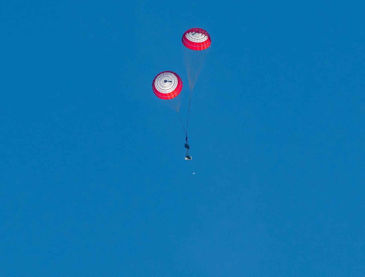 The drogue parachutes of the SpaceX Crew Dragon Freedom spacecraft are seen after being released during the landing of NASA astronauts Kjell Lindgren, Robert Hines, Jessica Watkins, and ESA (European Space Agency) astronaut Samantha Cristoforetti aboard in the Atlantic Ocean off the coast of Jacksonville, Florida, Friday, Oct. 14, 2022. Lindgren, Hines, Watkins, and Cristoforetti are returning after 170 days in space as part of Expeditions 67 and 68 aboard the International Space Station. Photo Credit: (NASA/Bill Ingalls)