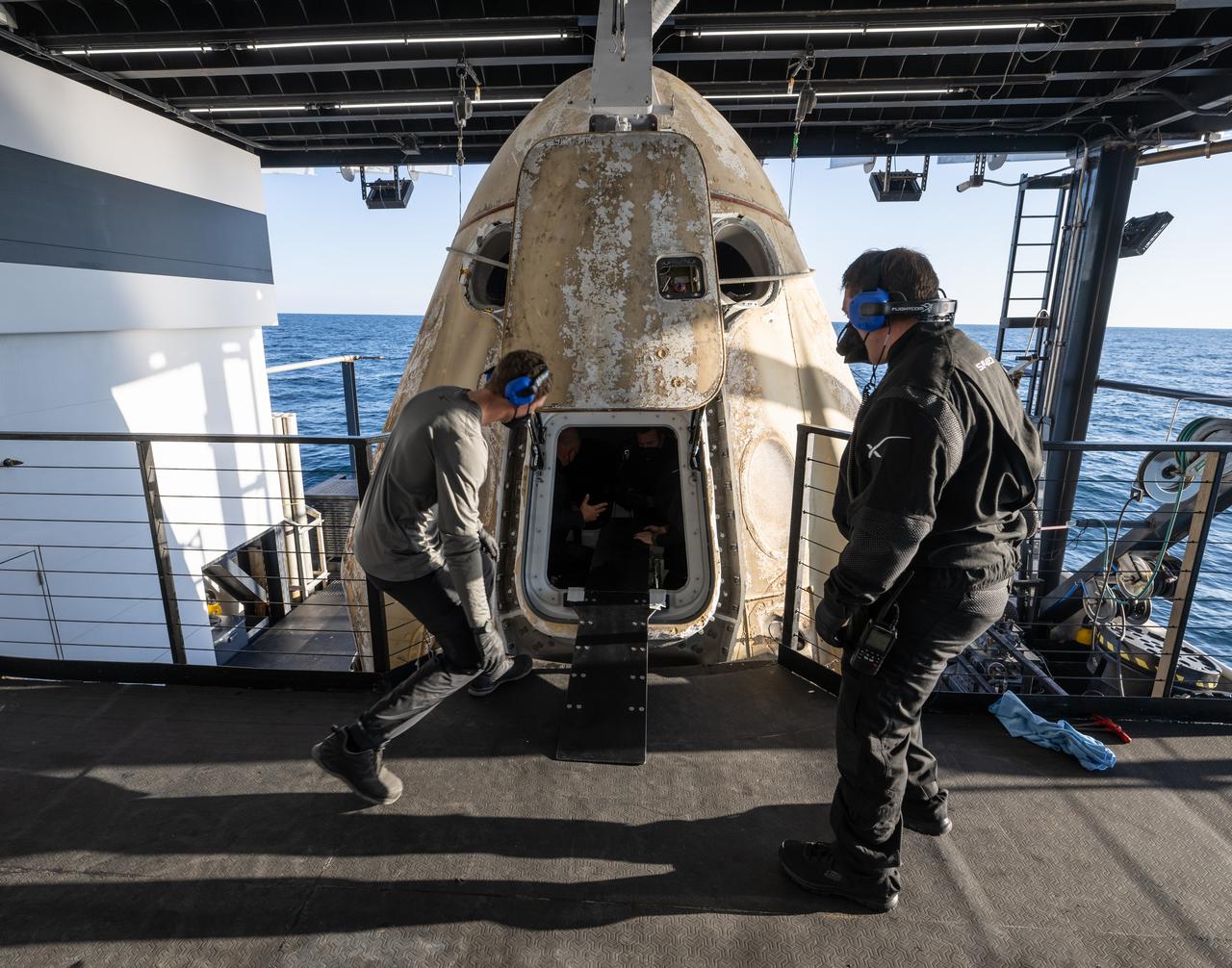Support teams work around the SpaceX Crew Dragon Freedom spacecraft onboard the recovery ship Megan, after the capsule landed with NASA astronauts Kjell Lindgren, Robert Hines, Jessica Watkins, and ESA (European Space Agency) astronaut Samantha Cristoforetti aboard in the Atlantic Ocean off the coast of Jacksonville, Florida, Friday, Oct. 14, 2022. Lindgren, Hines, Watkins, and Cristoforetti are returning after 170 days in space as part of Expeditions 67 and 68 aboard the International Space Station. Photo Credit: (NASA/Bill Ingalls)
