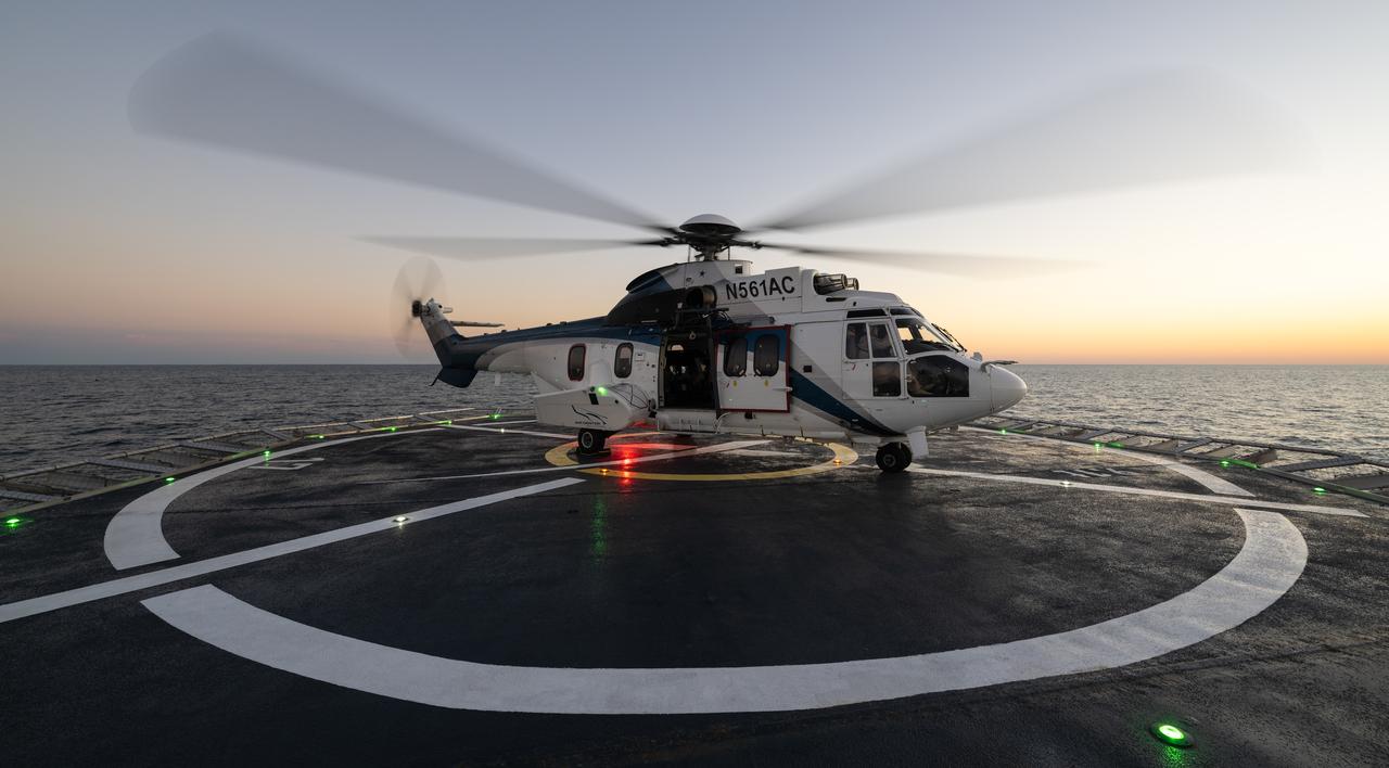 The helicopter that will transport NASA astronauts Kjell Lindgren, Robert Hines, Jessica Watkins, and ESA (European Space Agency) astronaut Samantha Cristoforetti to Jacksonville, Florida is seen on the deck of the SpaceX recovery ship Megan in the Atlantic Ocean, Friday, Oct. 14, 2022. Lindgren, Hines, Watkins, and Cristoforetti returned after 170 days in space as part of Expeditions 67 and 68 aboard the International Space Station. Photo Credit: (NASA/Bill Ingalls)