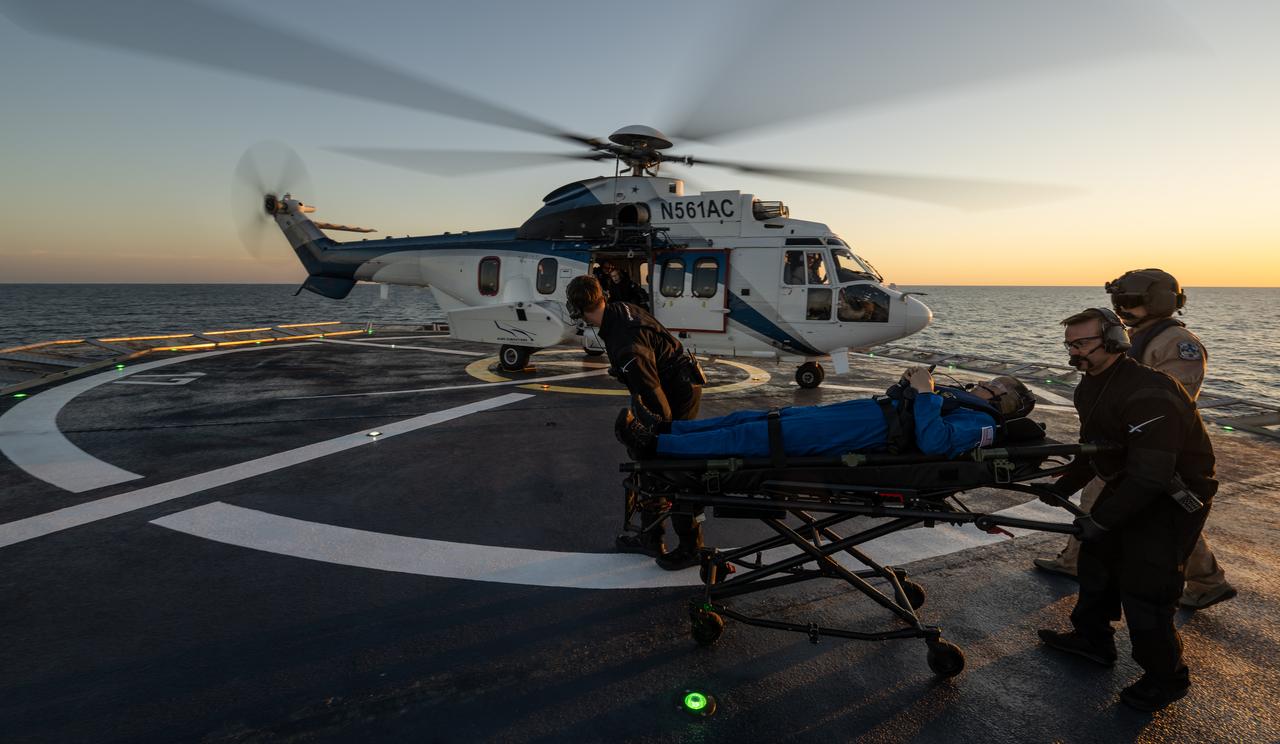 NASA astronaut Robert Hines is helped aboard a helicopter on the SpaceX recovery ship Megan to fly to Jacksonville, Florida, with NASA astronauts Kjell Lindgren and Jessica Watkins, along with ESA (European Space Agency) astronaut Samantha Cristoforetti, after the four landed in their SpaceX Crew Dragon Freedom spacecraft in the Atlantic Ocean off the coast of Jacksonville, Friday, Oct. 14, 2022. Lindgren, Hines, Watkins, and Cristoforetti are returning after 170 days in space as part of Expeditions 67 and 68 aboard the International Space Station. Photo Credit: (NASA/Bill Ingalls)