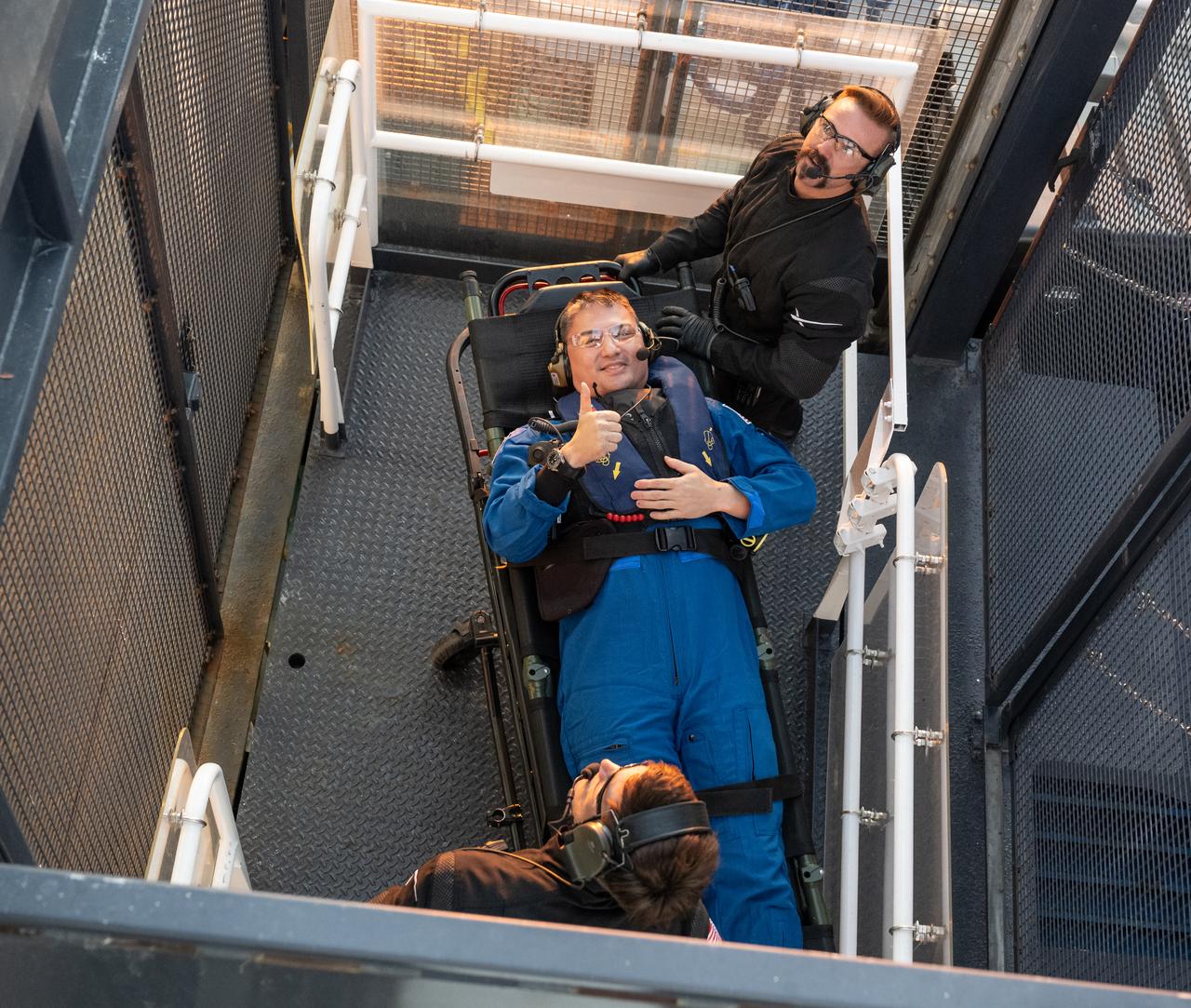 NASA astronaut Kjell Lindgren is seen inside an elevator on the SpaceX recovery ship Megan that will take him up to a waiting helicopter to fly to Jacksonville, Florida with NASA astronauts Robert Hines, and Jessica Watkins, along with ESA (European Space Agency) astronaut Samantha Cristoforetti, just a couple of hours after the four landed in their SpaceX Crew Dragon Freedom spacecraft in the Atlantic Ocean, Friday, Oct. 14, 2022. Lindgren, Hines, Watkins, and Cristoforetti are returning after 170 days in space as part of Expeditions 67 and 68 aboard the International Space Station. Photo Credit: (NASA/Bill Ingalls)