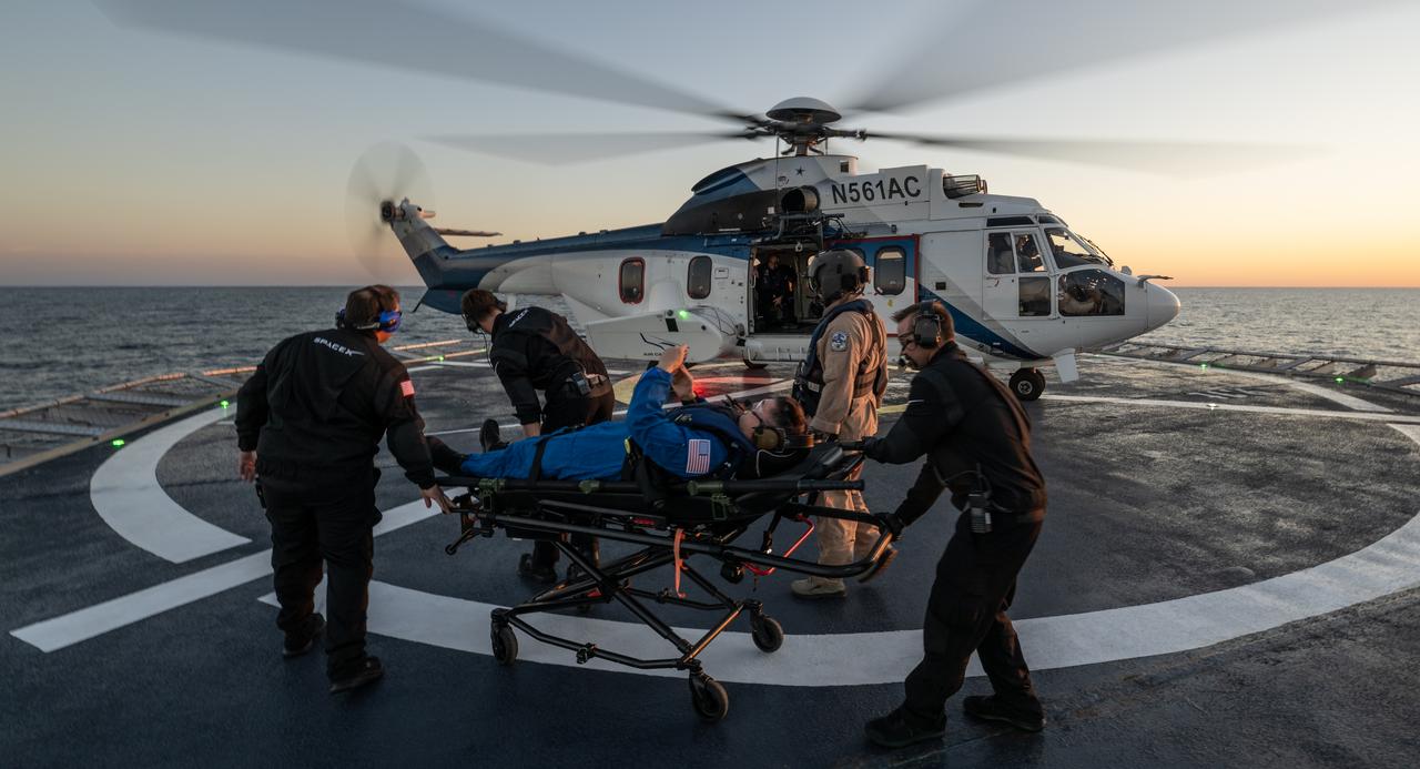 NASA astronaut Kjell Lindgren is helped aboard a helicopter on the SpaceX recovery ship Megan to fly to Jacksonville, Florida with NASA astronauts Robert Hines and Jessica Watkins, along with ESA (European Space Agency) astronaut Samantha Cristoforetti, after the four landed in their SpaceX Crew Dragon Freedom spacecraft in the Atlantic Ocean off the coast of Jacksonville, Friday, Oct. 14, 2022. Lindgren, Hines, Watkins, and Cristoforetti are returning after 170 days in space as part of Expeditions 67 and 68 aboard the International Space Station. Photo Credit: (NASA/Bill Ingalls)