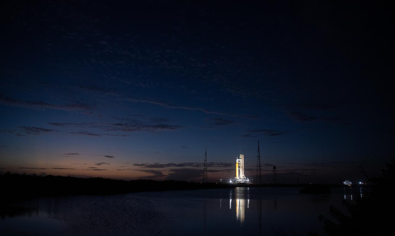 NASA’s Space Launch System (SLS) rocket with the Orion spacecraft aboard is seen illuminated by spotlights after sunset atop the mobile launcher at Launch Pad 39B as preparations for launch continue, Sunday, Nov. 6, 2022, at NASA’s Kennedy Space Center in Florida. NASA’s Artemis I flight test is the first integrated test of the agency’s deep space exploration systems: the Orion spacecraft, SLS rocket, and supporting ground systems. Launch of the uncrewed flight test is targeted for Nov. 14 at 12:07 a.m. EST. Photo Credit: (NASA/Joel Kowsky)