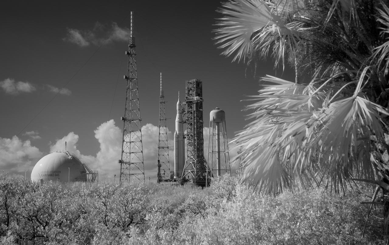 NASA’s Space Launch System (SLS) rocket with the Orion spacecraft aboard atop a mobile launcher is seen in this black and white infrared exposure at Launch Pad 39B as preparations for launch continue, Monday, Nov. 14, 2022, at NASA’s Kennedy Space Center in Florida. NASA’s Artemis I flight test is the first integrated test of the agency’s deep space exploration systems: the Orion spacecraft, SLS rocket, and supporting ground systems. Launch of the uncrewed flight test is targeted for no earlier than Nov. 16 at 1:04 a.m. EST. Photo Credit: (NASA/Bill Ingalls)