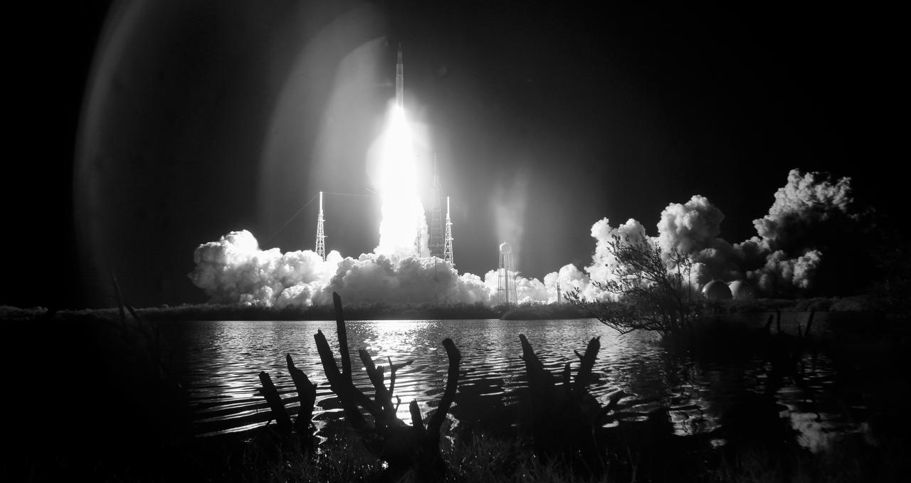 In this black and white infrared image, NASA’s Space Launch System rocket carrying the Orion spacecraft launches on the Artemis I flight test, Wednesday, Nov. 16, 2022, from Launch Complex 39B at NASA’s Kennedy Space Center in Florida. NASA’s Artemis I mission is the first integrated flight test of the agency’s deep space exploration systems: the Orion spacecraft, Space Launch System (SLS) rocket, and ground systems. SLS and Orion launched at 1:47 a.m. EST, from Launch Pad 39B at the Kennedy Space Center. Photo Credit: (NASA/Joel Kowsky)