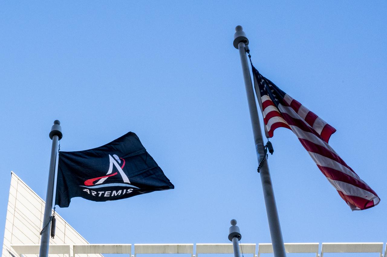 Artemis Mission Development Manager Mike Sarafin, Artemis Mission Integration Manager Sheela Logan, and Assistant Deputy Associate Administrator for Exploration Systems Development Tom Whitmeyer raise Artemis flags Wednesday, Nov. 23, 2022, at the Mary W. Jackson NASA Headquarters building in Washington. Photo Credit: (NASA/Keegan Barber)