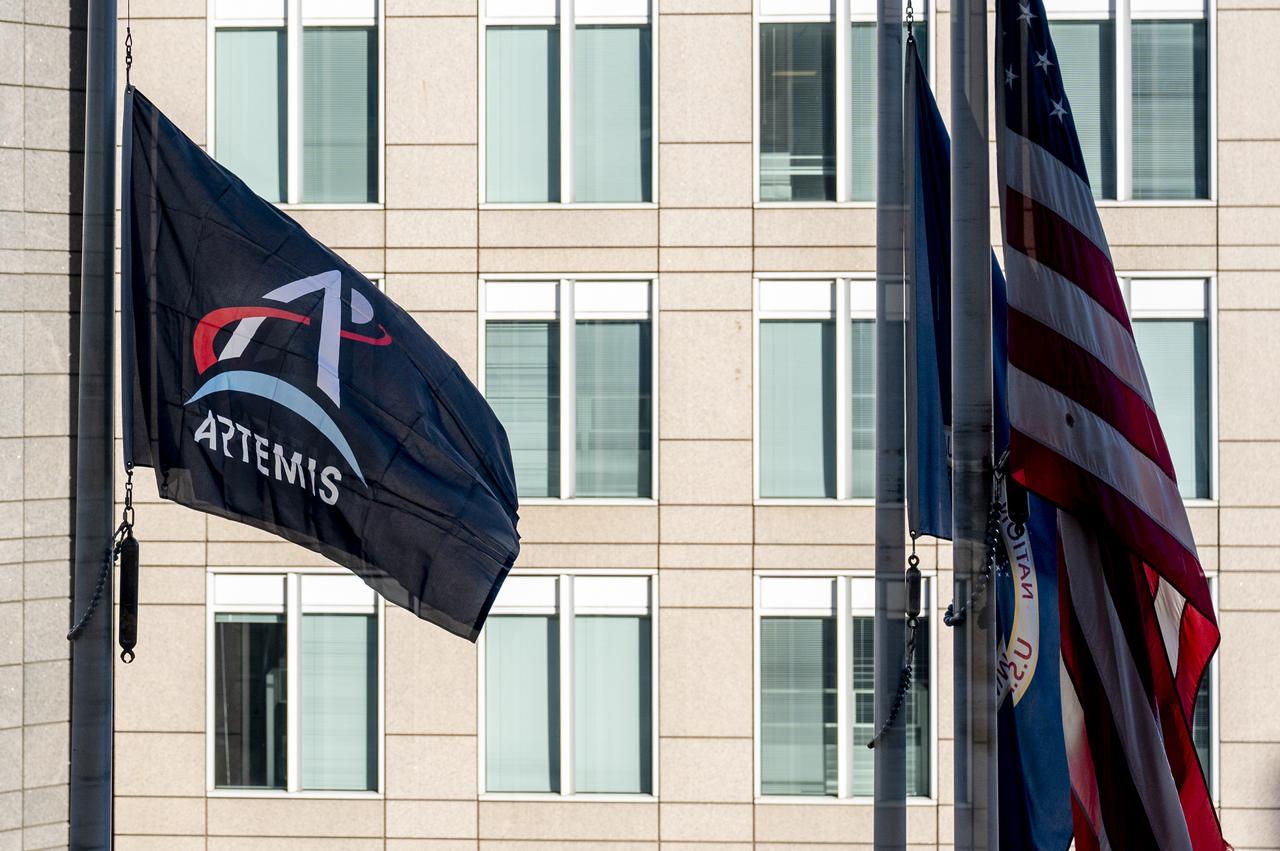 Artemis Mission Development Manager Mike Sarafin, Artemis Mission Integration Manager Sheela Logan, and Assistant Deputy Associate Administrator for Exploration Systems Development Tom Whitmeyer raise Artemis flags Wednesday, Nov. 23, 2022, at the Mary W. Jackson NASA Headquarters building in Washington. Photo Credit: (NASA/Keegan Barber)