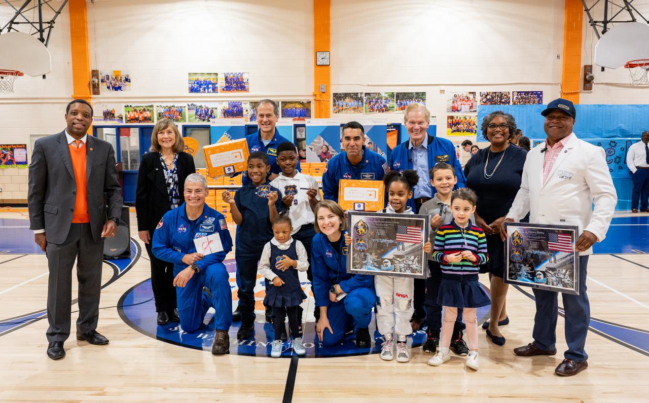 NASA Administrator Bill Nelson and NASA astronauts Raja Chari, Kayla Barron, Tom Marshburn, and Mark Vande Hei pose for a photo with students during their visit to Amidon-Bowen Elementary School, Thursday, Dec. 8, 2022, in Washington. Vande Hei spent 355 days in space as a member of Expedition 65/66 and was joined during Expedition 66 by Marshburn, Chari, and Barron who spent 177 days onboard the International Space Station. Photo Credit: (NASA/Keegan Barber)