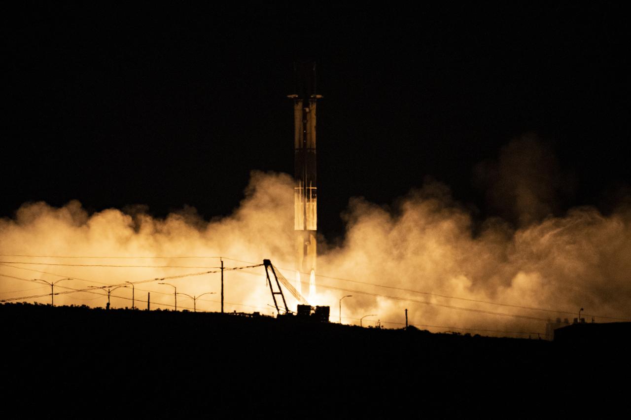 A SpaceX Falcon 9 first-stage booster returns to the landing pad following the launch of the Surface Water and Ocean Topography (SWOT) spacecraft, Friday, Dec. 16, 2022, from Space Launch Complex 4E at Vandenberg Space Force Base in California. Jointly developed by NASA and Centre National D'Etudes Spatiales (CNES), with contributions from the Canadian Space Agency (CSA) and United Kingdom Space Agency, SWOT is the first satellite mission that will observe nearly all water on Earth’s surface, measuring the height of water in the planet’s lakes, rivers, reservoirs, and the ocean. Photo Credit: (NASA/Keegan Barber)