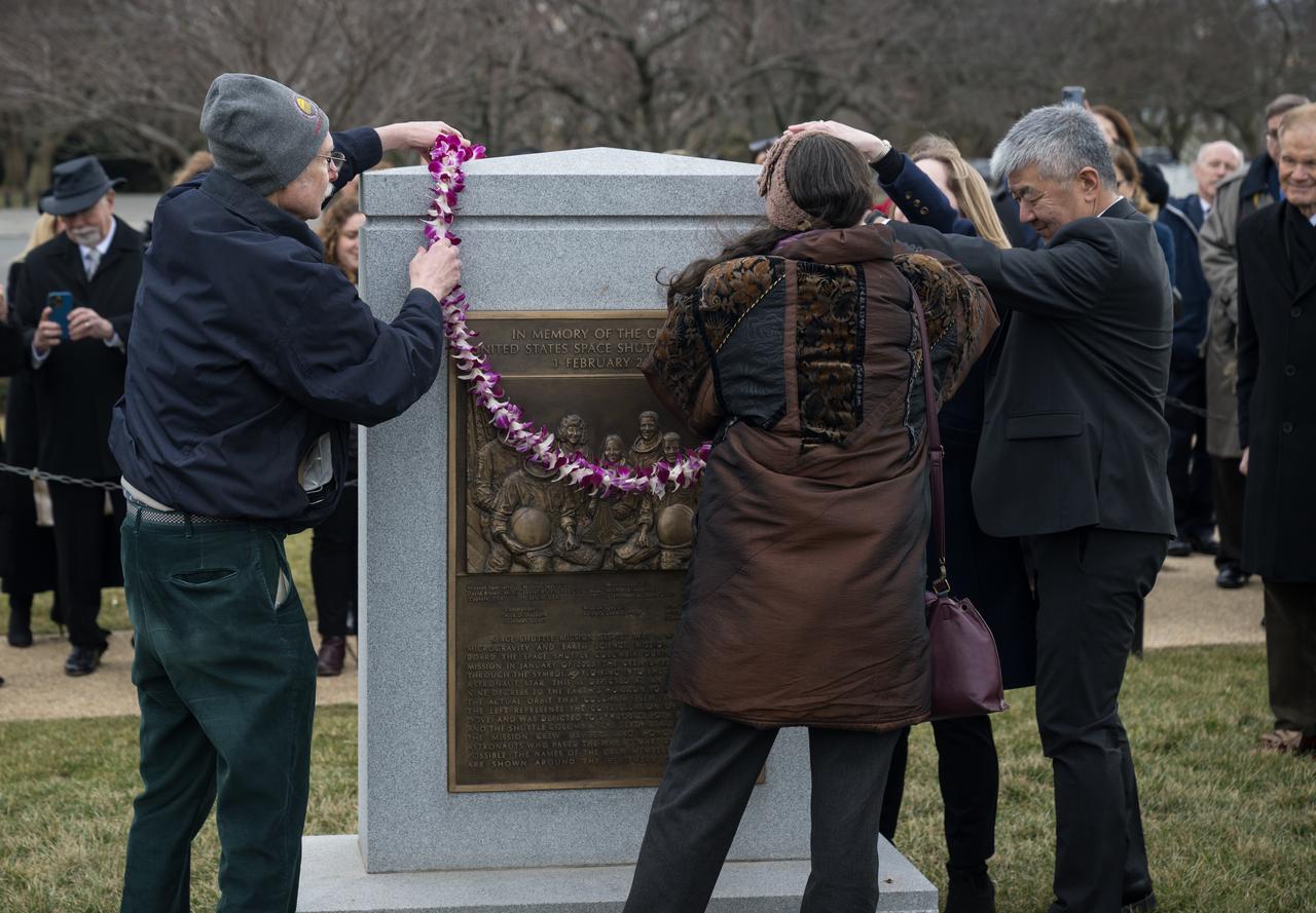Columbia astronaut William McCool’s family representatives Jane Tani and Dan Tani, right, as well as family of Challenger astronaut Judy Resnik, Chuck Resnik, left, and Amy Resnik, center, help place a lei at the Space Shuttle Columbia Memorial during a wreath laying ceremony that was part of NASA's Day of Remembrance, Thursday, Jan. 26, 2023, at Arlington National Cemetery in Arlington, Va. Wreaths were laid in memory of those men and women who lost their lives in the quest for space exploration.  Photo Credit: (NASA/Aubrey Gemignani)