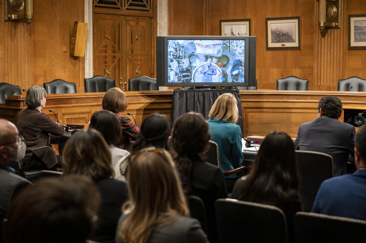 NASA astronaut Nicole Mann, Expedition 68 Flight Engineer, is seen from onboard the International Space Station (ISS) during a briefing with members of the House of Representatives, the Indian Affairs Committee, and the Senate Native American Affairs Committee, Tuesday, Feb. 7, 2023, at the Dirksen Senate Office Building in Washington.  Mann answered questions from members of the committees during a live downlink from the International Space Station. Photo Credit: (NASA/Keegan Barber)