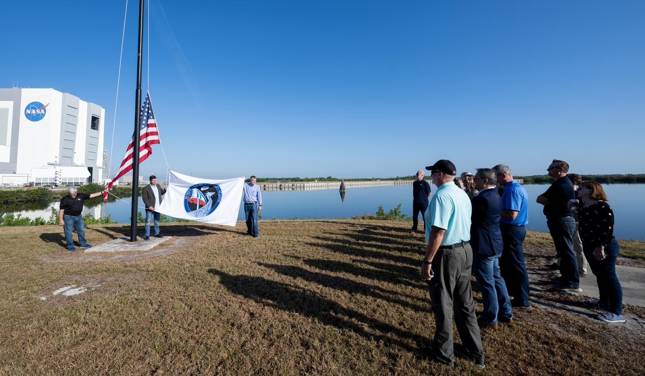 Trip Healey, manager, Program Control & Integration for NASA’s Commercial Crew Program, left, and Steve Stich, manager of NASA’s Commercial Crew Program right, prepare to raise the SpaceX Crew-6 flag, Wednesday, Feb. 22, 2023, at NASA’s Kennedy Space Center in Florida. NASA’s SpaceX Crew-6 mission is the sixth crew rotation mission of the SpaceX Dragon spacecraft and Falcon 9 rocket to the International Space Station as part of the agency’s Commercial Crew Program. NASA astronauts Stephen Bowen and Warren "Woody" Hoburg, UAE (United Arab Emirates) astronaut Sultan Alneyadi, and Roscosmos cosmonaut Andrey Fedyaev are scheduled to launch at 1:45 a.m. EST on Feb. 27 from Launch Complex 39A at the Kennedy Space Center. Photo Credit: (NASA/Joel Kowsky)