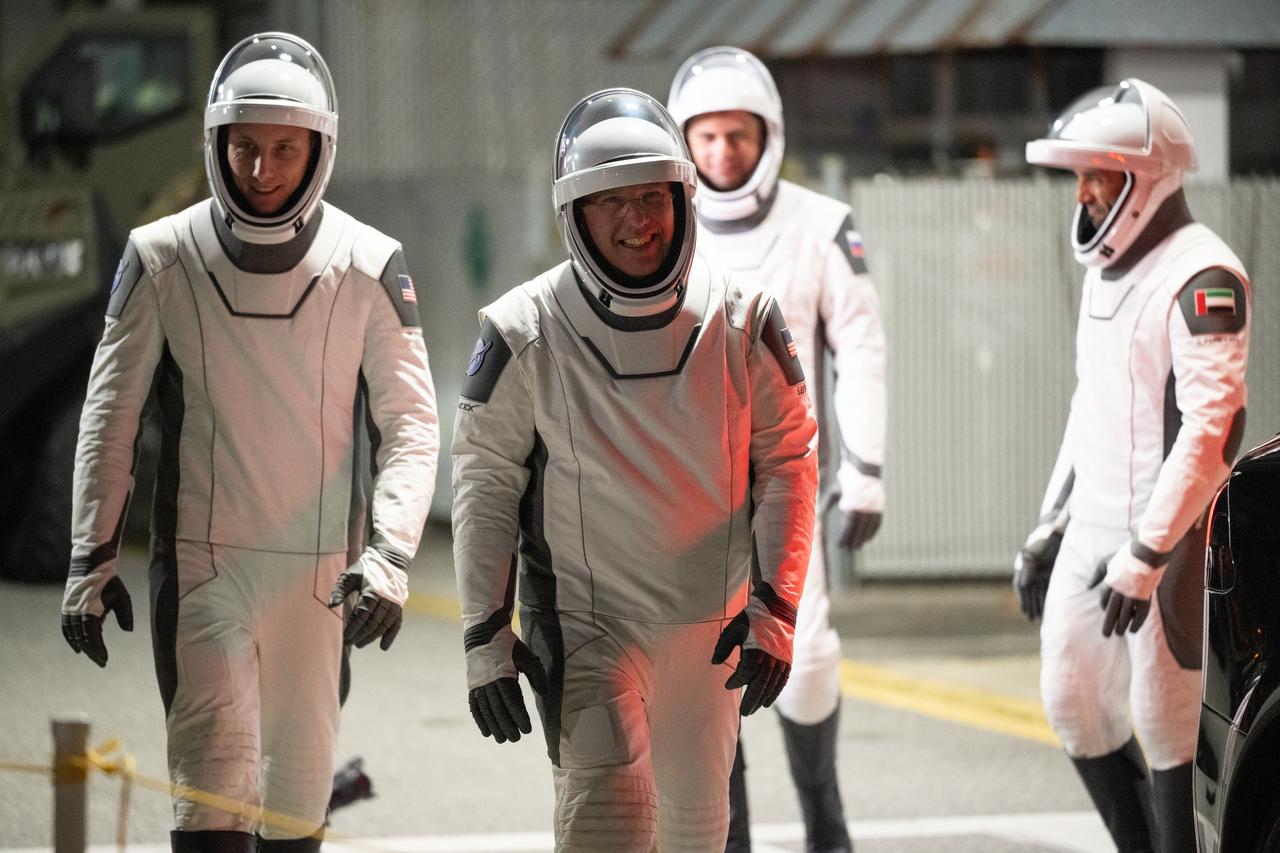 NASA astronauts Warren "Woody" Hoburg, left, and Stephen Bowen, right, are seen along with Roscosmos cosmonaut Andrey Fedyaev and UAE (United Arab Emirates) astronaut Sultan Alneyadi, wearing SpaceX spacesuits, are seen as they prepare to depart the Neil  A. Armstrong Operations and Checkout Building for Launch Complex 39A during a dress rehearsal prior to the Crew-6 mission launch, Thursday, Feb. 23, 2023, at NASA’s Kennedy Space Center in Florida. NASA’s SpaceX Crew-6 mission is the sixth crew rotation mission of the SpaceX Dragon spacecraft and Falcon 9 rocket to the International Space Station as part of the agency’s Commercial Crew Program. Bowen, Hoburg, Alneyadi, and Fedyaev are scheduled to launch at 1:45 a.m. EST on Feb. 27, from Launch Complex 39A at the Kennedy Space Center. Photo Credit: (NASA/Joel Kowsky)