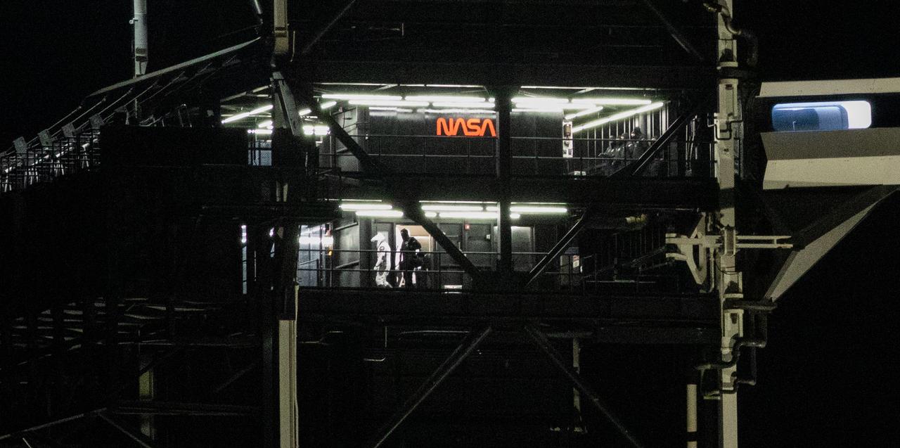 NASA astronauts Stephen Bowen and Warren "Woody" Hoburg are seen as they exit the elevator on the fixed service structure of Launch Complex 39A before boarding SpaceX’s Dragon spacecraft atop the company’s Falcon 9 rocket before the launch of NASA’s SpaceX Crew-6 mission to the International Space Station, Wednesday, March 1, 2023, at NASA’s Kennedy Space Center in Florida. NASA’s SpaceX Crew-6 mission is the sixth crew rotation mission of the SpaceX Dragon spacecraft and Falcon 9 rocket to the International Space Station as part of the agency’s Commercial Crew Program. Bowen, Hoburg, Roscosmos cosmonaut Andrey Fedyaev, and UAE (United Arab Emirates) astronaut Sultan Alneyadi launched at 12:34 a.m. EST from Launch Complex 39A at the Kennedy Space Center to begin a six month mission aboard the orbital outpost. Photo Credit: (NASA/Joel Kowsky)