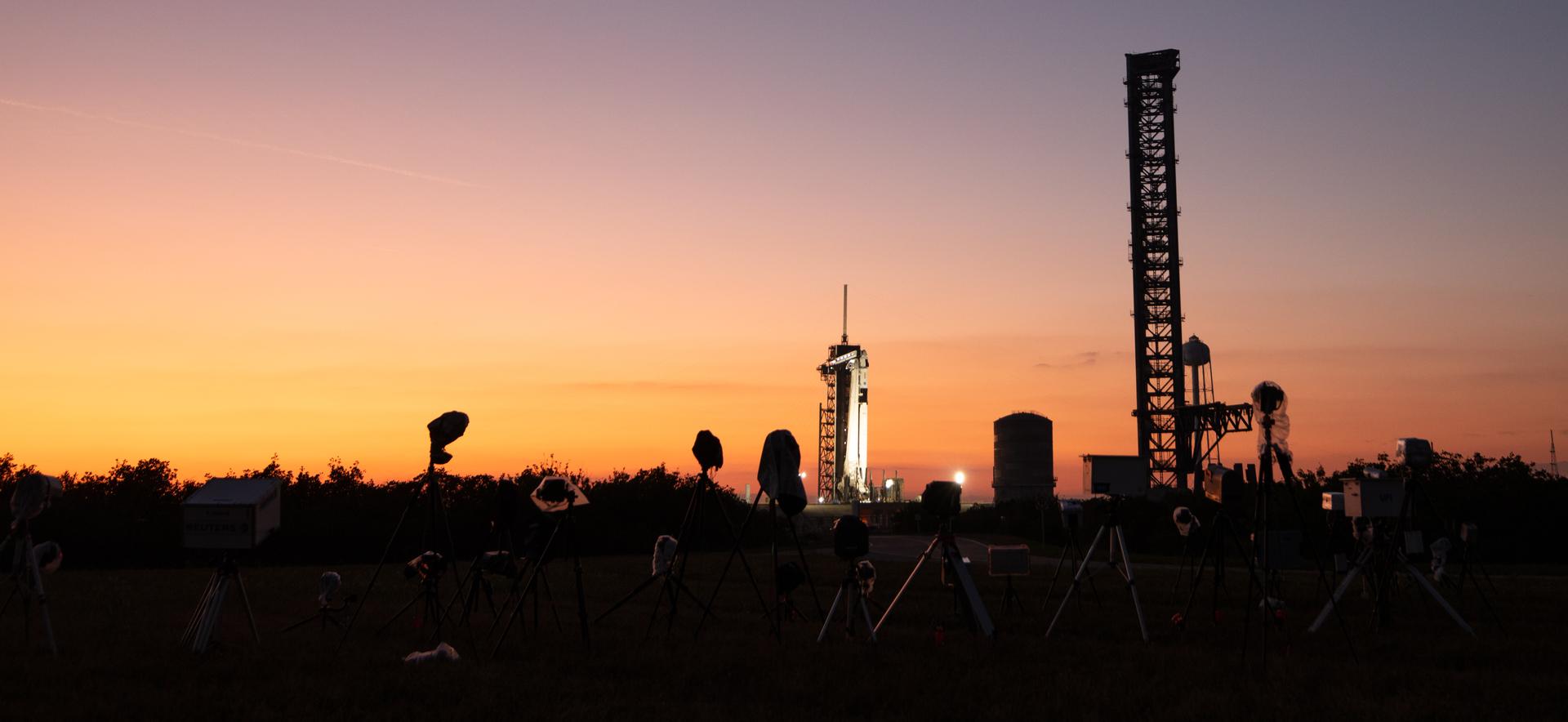 Sunset picture showing rocket and spacecraft on launch pad.