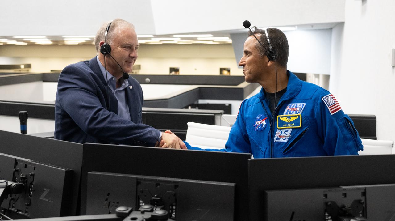 Norm Knight, director of Flight Operations at NASA's Johnson Space Center, left, and Joe Acaba, Chief of the Astronaut Office, shake hands following the launch of a SpaceX Falcon 9 rocket carrying the company's Dragon spacecraft on the Crew-6 mission with NASA astronauts Stephen Bowen and Warren "Woody" Hoburg, UAE (United Arab Emirates) astronaut Sultan Alneyadi, and Roscosmos cosmonaut Andrey Fedyaev onboard, Thursday, March 2, 2023, in firing room four of the Rocco A. Petrone Launch Control Center at NASA’s Kennedy Space Center in Florida. NASA’s SpaceX Crew-6 mission is the sixth crew rotation mission of the SpaceX Dragon spacecraft and Falcon 9 rocket to the International Space Station as part of the agency’s Commercial Crew Program. Bowen, Hoburg, Alneyadi, and Fedyaev launched at 12:34 a.m. EST, from Launch Complex 39A at the Kennedy Space Center to begin a six month mission aboard the International Space Station. Photo Credit: (NASA/Joel Kowsky)