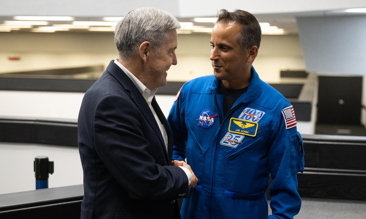 Bob Cabana, NASA associate administrator, left, and Joe Acaba, Chief of the Astronaut Office, right, shake hands following the launch of a SpaceX Falcon 9 rocket carrying the company's Dragon spacecraft on the Crew-6 mission with NASA astronauts Stephen Bowen and Warren "Woody" Hoburg, UAE (United Arab Emirates) astronaut Sultan Alneyadi, and Roscosmos cosmonaut Andrey Fedyaev onboard, Thursday, March 2, 2023, in  firing room four of the Rocco A. Petrone Launch Control Center at NASA’s Kennedy Space Center in Florida. NASA’s SpaceX Crew-6 mission is the sixth crew rotation mission of the SpaceX Dragon spacecraft and Falcon 9 rocket to the International Space Station as part of the agency’s Commercial Crew Program. Bowen, Hoburg, Alneyadi, and Fedyaev launched at 12:34 a.m. EST, from Launch Complex 39A at the Kennedy Space Center to begin a six month mission aboard the International Space Station. Photo Credit: (NASA/Joel Kowsky)