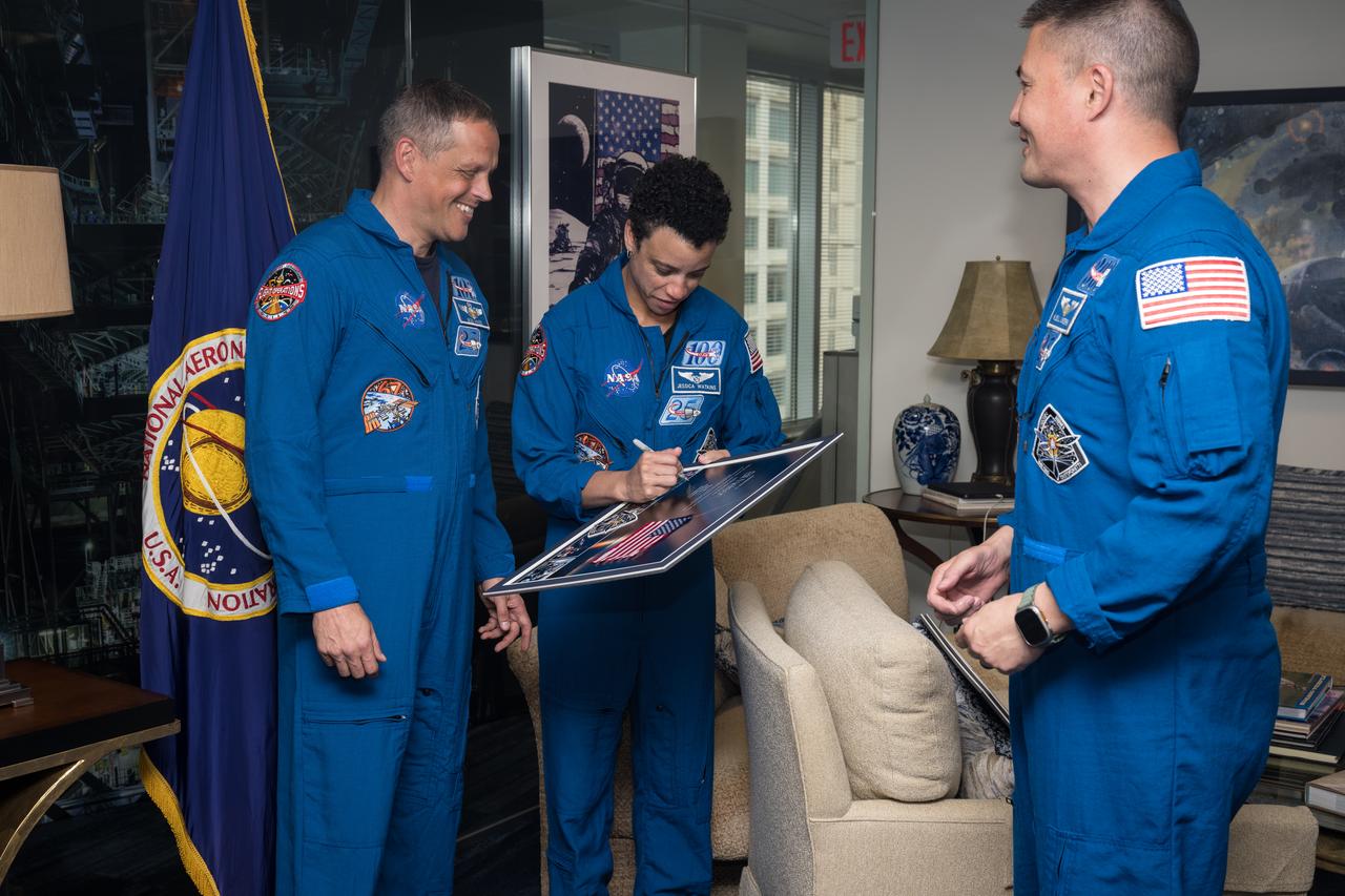 NASA’s SpaceX Crew-4 NASA astronauts Robert Hines, Jessica Watkins, and Kjell Lindgren, sign montages from their mission for NASA leadership, Monday, March 27, 2023, at the Mary W. Jackson NASA Headquarters building in Washington DC. Photo Credit: (NASA/Aubrey Gemignani)