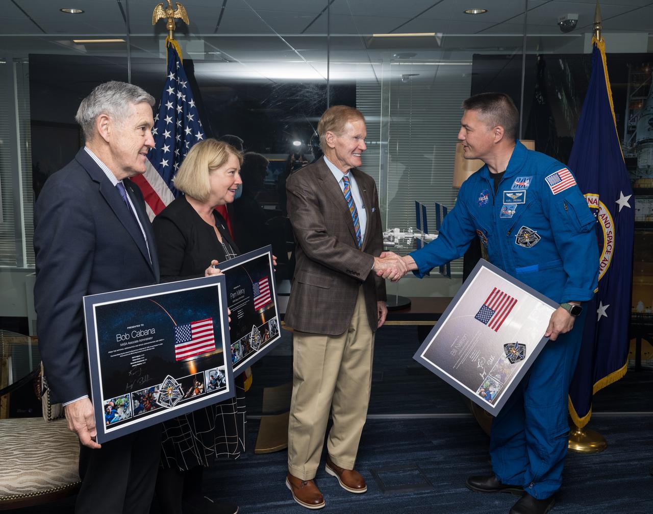 From left to right, NASA Associate Administrator Bob Cabana, NASA Deputy Administrator, Pam Melroy, and NASA Administrator Bill Nelson receive signed montages from NASA’s SpaceX Crew-4 NASA astronauts Kjell Lindgren, right, Jessica Watkins, and Robert Hines, Monday, March 27, 2023, at the Mary W. Jackson NASA Headquarters building in Washington DC. Photo Credit: (NASA/Aubrey Gemignani)