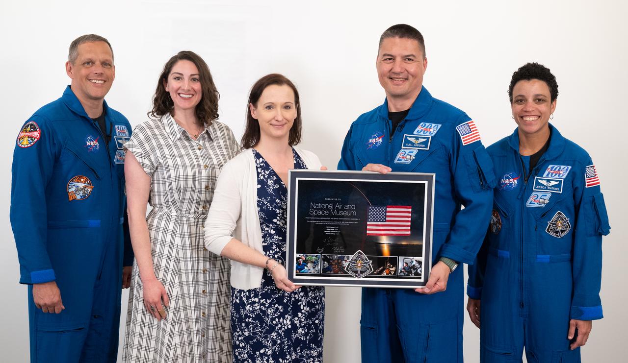 NASA astronauts Robert Hines, left, Kjell Lindgren, second from right, and Jessica Watkins, right, pose for a picture with Smithsonian National Air and Space Museum curators Emily Margolis, second from left and Jennifer Levasseur, center, after presenting a montage from their mission to the International Space Station, Tuesday, March 28, 2023 at the Smithsonian’s National Air and Space Museum in Washington. Lindgren, Hines, and Watkins spent 170 days in space as part of Expeditions 67 and 68 aboard the International Space Station. Photo Credit: (NASA/Joel Kowsky)