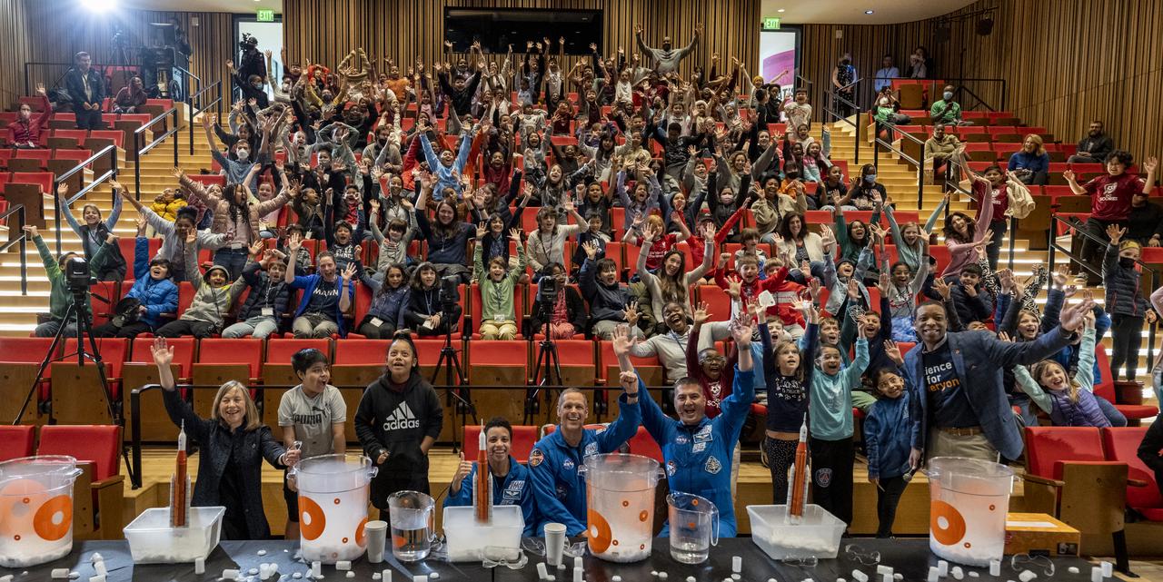 NASA astronauts Kjell Lindgren, Jessica Watkins, and Robert Hines pose for a group photo with local students at the Martin Luther King Jr Memorial Library, Thursday, March 30, 2023, in Washington. Lindgren, Hines, and Watkins spent 170 days in space as part of Expeditions 67 and 68 aboard the International Space Station.  Photo Credit: (NASA/Keegan Barber)