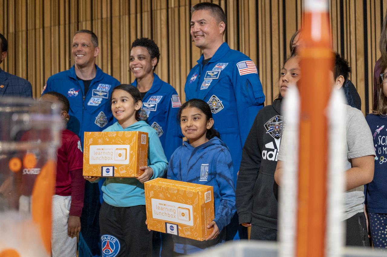 NASA astronauts Kjell Lindgren, Jessica Watkins, and Robert Hines pose for a group photo with local students at the Martin Luther King Jr Memorial Library, Thursday, March 30, 2023, in Washington. Lindgren, Hines, and Watkins spent 170 days in space as part of Expeditions 67 and 68 aboard the International Space Station.  Photo Credit: (NASA/Keegan Barber)