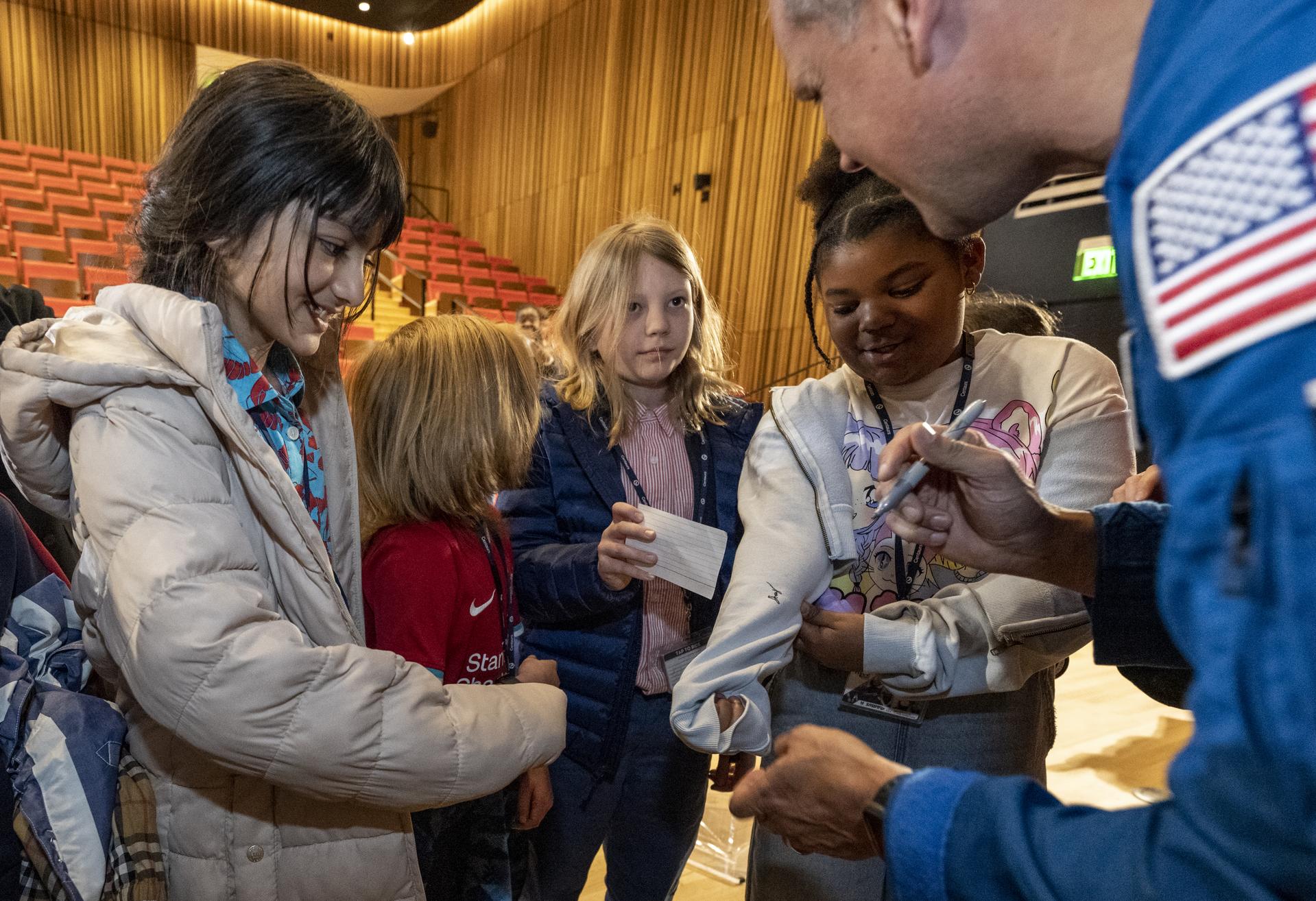 Astronaut Robert Hines Signing Autograph for Students