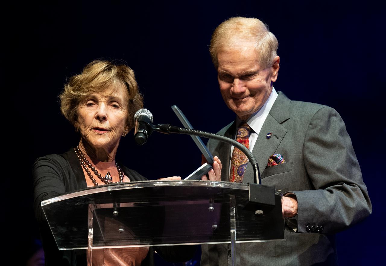 Jeannie Schulz, widow of Peanuts gang creator Charles M. Schulz, left, speaks after being presented with a NASA Exceptional Achievement Medal by NASA Administrator Bill Nelson, Wednesday, April 5, 2023, at the “Our Blue Planet” concert at the John F. Kennedy Center for the Performing Arts in Washington. Snoopy rode along as the zero gravity indicator on NASA’s Artemis I mission as part of a partnership with the agency and continues to help NASA inspire kids of all ages to follow along with Artemis missions.  Photo Credit: (NASA/Joel Kowsky)