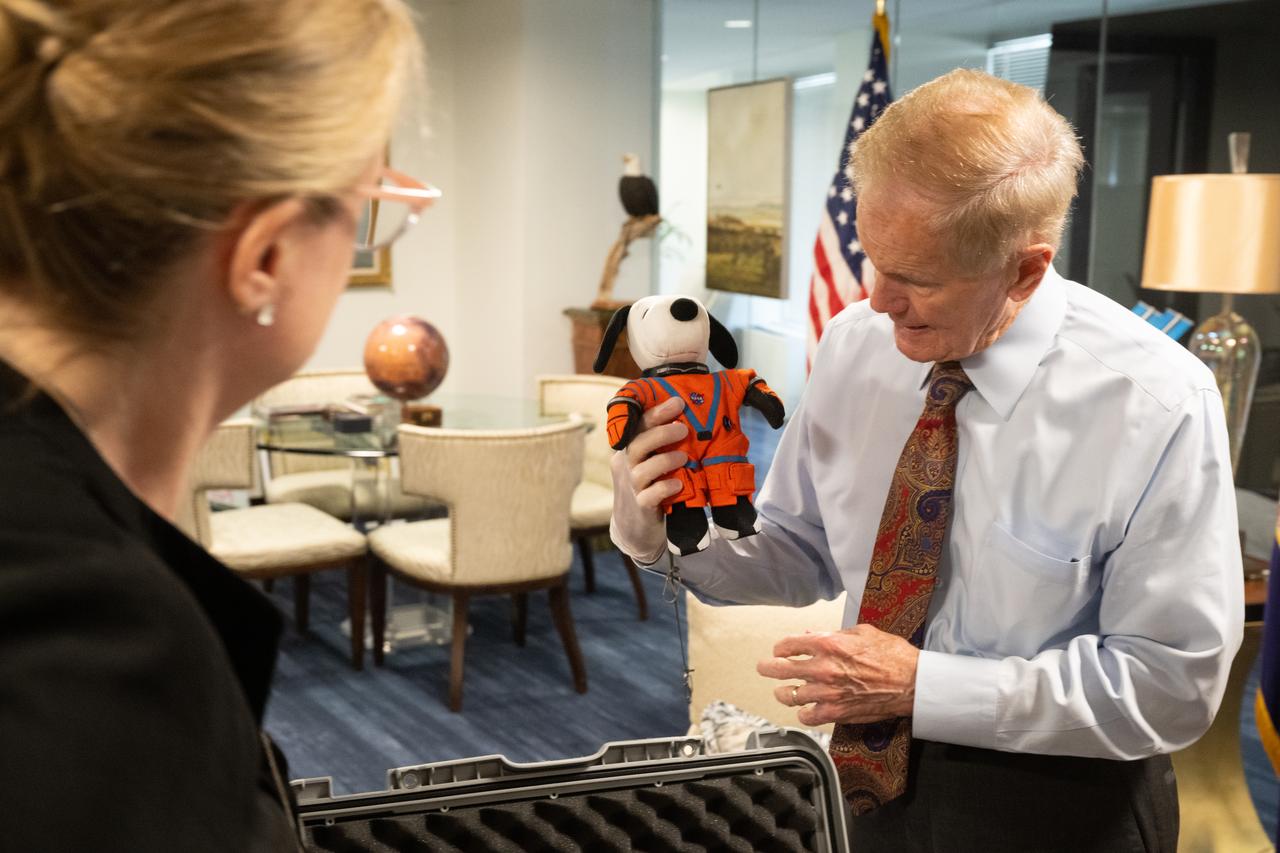 NASA Administrator Bill Nelson, holding the Artemis I Snoopy zero gravity indicator, is seen during a visit with Jeannie Schulz, widow of Peanuts gang creator Charles M. Schulz, Wednesday, April 5, 2023, at the Mary W. Jackson NASA Headquarters building in Washington. Schulz awarded a NASA Exceptional Achievement Medal by Administrator Nelson at an “Our Blue Planet” concert at the John F. Kennedy Center for the Performing Arts. Snoopy rode along as the zero gravity indicator on NASA’s Artemis I mission as part of a partnership with the agency and continues to help NASA inspire kids of all ages to follow along with Artemis missions. As part of the visit, Schulz showed the flown Artemis I Snoopy zero gravity indicator before it goes to its final home for display at the Schulz Museum in Santa Rosa, California.  Photo Credit: (NASA/Joel Kowsky)