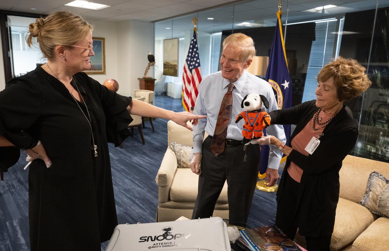 Melissa Menta, executive vice president at Peanuts Worldwide, left, NASA Administrator Bill Nelson, center, and Jeannie Schulz, widow of Peanuts gang creator Charles M. Schulz, left, holding the Artemis I Snoopy zero gravity indicator, are seen, Wednesday, April 5, 2023, during a visit to the Mary W. Jackson NASA Headquarters building in Washington. Schulz awarded a NASA Exceptional Achievement Medal by Administrator Nelson at an “Our Blue Planet” concert at the John F. Kennedy Center for the Performing Arts. Snoopy rode along as the zero gravity indicator on NASA’s Artemis I mission as part of a partnership with the agency and continues to help NASA inspire kids of all ages to follow along with Artemis missions. As part of the visit, Schulz showed the flown Artemis I Snoopy zero gravity indicator before it goes to its final home for display at the Schulz Museum in Santa Rosa, California.  Photo Credit: (NASA/Joel Kowsky)