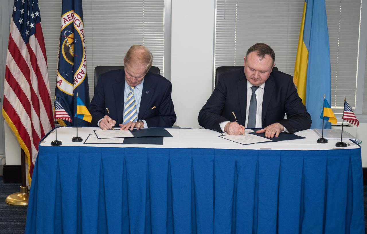 NASA Administrator Bill Nelson, left, and Deputy Chairman of the State Space Agency of Ukraine, Volodymyr Mikheiev, sign a joint statement on civil space cooperation between NASA and the State Space Agency of Ukraine, Friday April 21, 2023 at the Mary W. Jackson NASA Headquarters building in Washington DC. Photo Credit: (NASA/Aubrey Gemignani)
