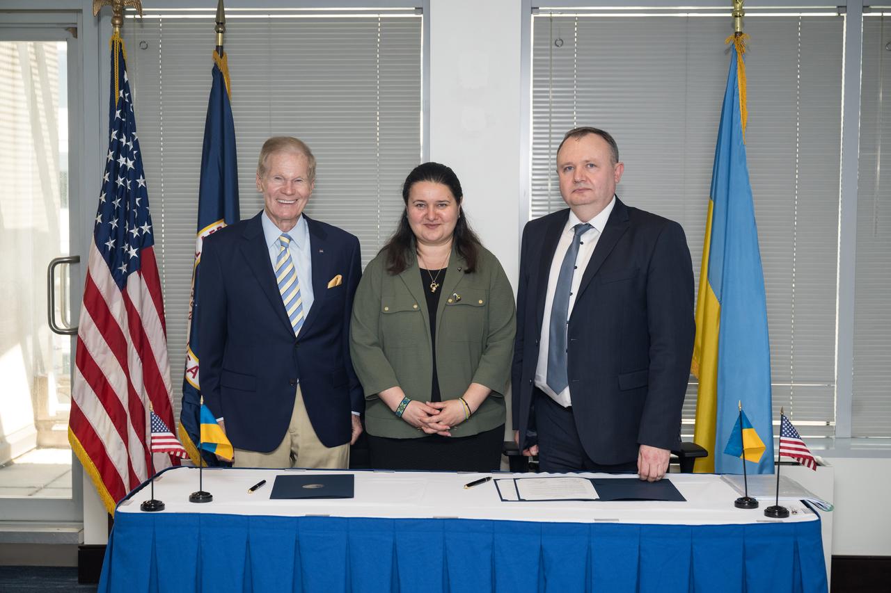 From left to right, NASA Administrator Bill Nelson, Ambassador of Ukraine, Her Excellency Oksana Markarova, and Deputy Chairman of the State Space Agency of Ukraine, Volodymyr Mikheiev, pose for a photo after Nelson and Mikheiev signed a joint statement on civil space cooperation between NASA and the State Space Agency of Ukraine, Friday April 21, 2023 at the Mary W. Jackson NASA Headquarters building in Washington DC. Photo Credit: (NASA/Aubrey Gemignani)