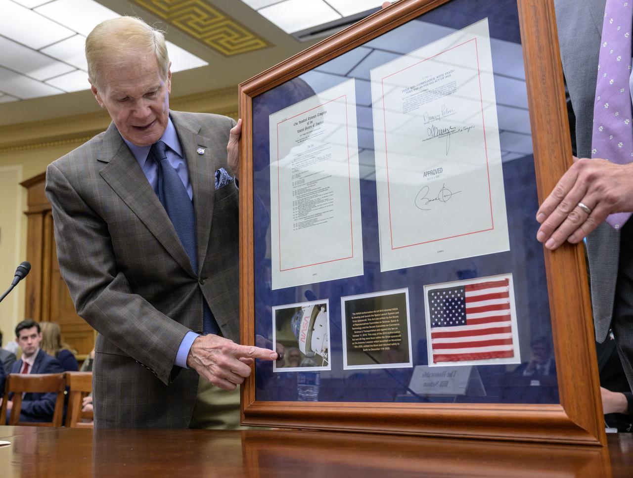 NASA Administrator Bill Nelson presents to the House Science, Space and Technology Committee, a plaque containing a copy of the NASA authorization Act of 2010 and a US flag that were flown within the Orion Spacecraft on the Artemis I mission and orbited the Moon, during a hearing on “An Overview of the Fiscal Year 2024 Proposed Budget Request for NASA,” Thursday, April 27, 2023 at the Rayburn House Office Building in Washington. Photo Credit: (NASA/Bill Ingalls)