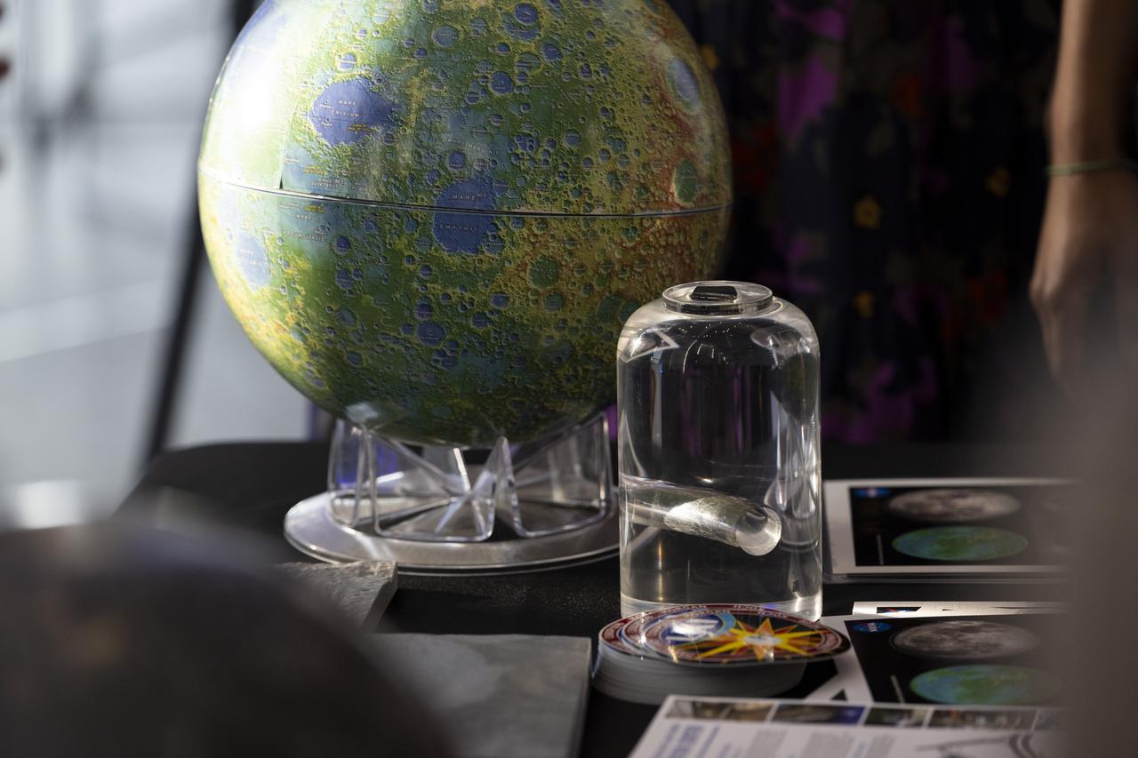 Attendees of the National Philharmonic performance of Henry Dehlinger’s “Cosmic Cycles” view a Moon rock, Thursday, May 11, 2023, at Capital One Hall in Tysons, Va. “Cosmic Cycles: A Space Symphony” is a collaboration between composer Henry Dehlinger, NASA’s Goddard Space Flight Center, and the National Philharmonic that features a fusion of music and video in seven multimedia works on the Sun, Earth, Moon, Planets, and Cosmos. Photo Credit: (NASA/Joel Kowsky)
