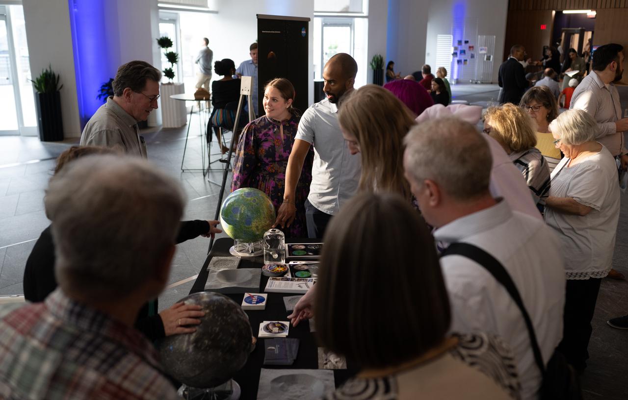 Attendees of the National Philharmonic performance of Henry Dehlinger’s “Cosmic Cycles” view a Moon rock, Thursday, May 11, 2023, at Capital One Hall in Tysons, Va. “Cosmic Cycles: A Space Symphony” is a collaboration between composer Henry Dehlinger, NASA’s Goddard Space Flight Center, and the National Philharmonic that features a fusion of music and video in seven multimedia works on the Sun, Earth, Moon, Planets, and Cosmos. Photo Credit: (NASA/Joel Kowsky)