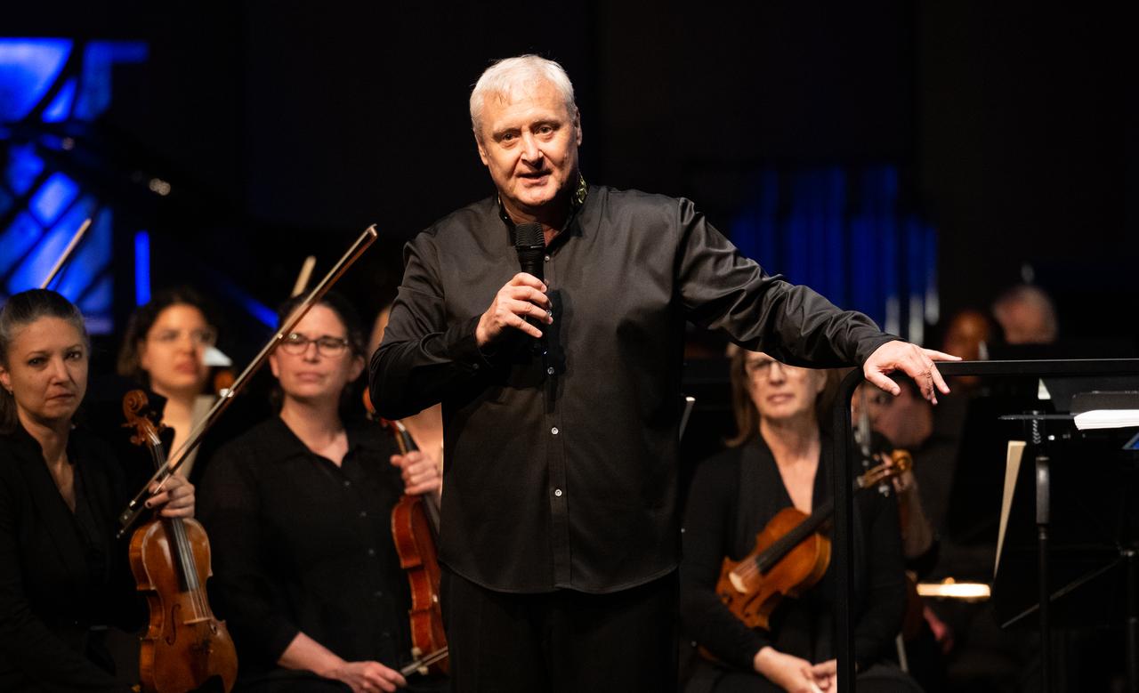 Maestro Piotr Gajewski speaks after conducting the National Philharmonic in the world premier performance of Henry Dehlinger’s “Cosmic Cycles,” Thursday, May 11, 2023, at Capital One Hall in Tysons, Va. “Cosmic Cycles: A Space Symphony” is a collaboration between composer Henry Dehlinger, NASA’s Goddard Space Flight Center, and the National Philharmonic that features a fusion of music and video in seven multimedia works on the Sun, Earth, Moon, Planets, and Cosmos.  Photo Credit: (NASA/Joel Kowsky)
