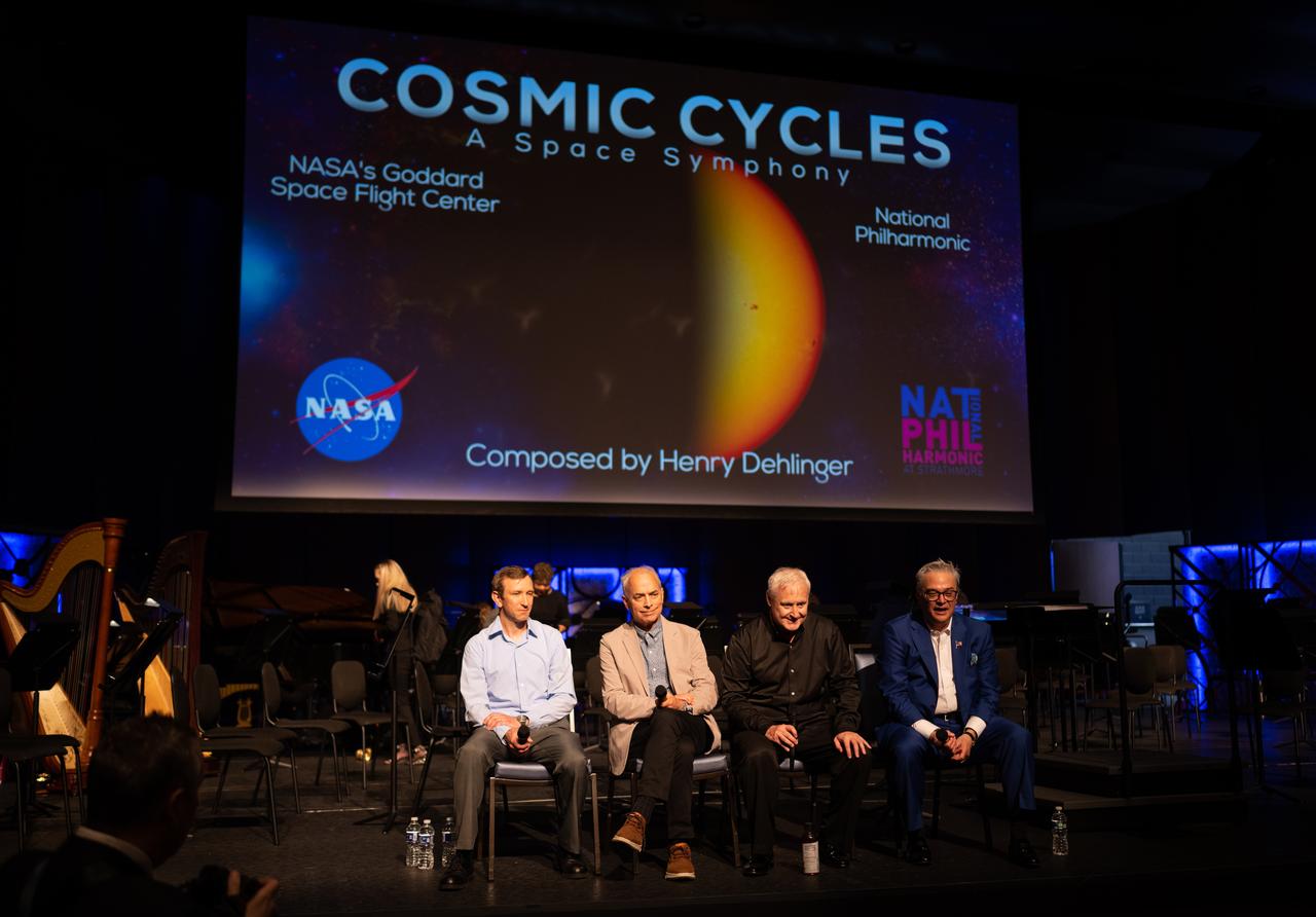 Scott Wiessinger, multimedia producer at NASA’s Goddard Space Flight Center, left, Wade Sisler, executive producer at NASA’s Goddard Space Flight Center, second from left, maestro Piotr Gajewski, second from right, composer Henry Dehlinger, right, are seen as they answer questions following the world premier performance of Dehlinger’s “Cosmic Cycles,” Thursday, May 11, 2023, at Capital One Hall in Tysons, Va. “Cosmic Cycles: A Space Symphony” is a collaboration between composer Henry Dehlinger, NASA’s Goddard Space Flight Center, and the National Philharmonic that features a fusion of music and video in seven multimedia works on the Sun, Earth, Moon, Planets, and Cosmos.  Photo Credit: (NASA/Joel Kowsky)