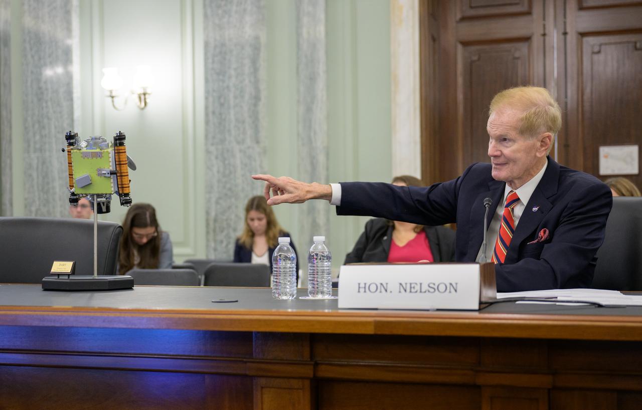NASA Administrator Bill Nelson points to a model of the DART spacecraft as he testifies before the Senate Committee on Commerce, Science, and Transportation during a hearing titled “Examining NASA’s Budget and Priorities,” Tuesday, May 16, 2023, at the Russell Senate Office Building in Washington. Photo Credit: (NASA/Bill Ingalls)