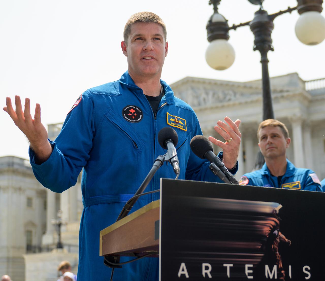 CSA (Canadian Space Agency) astronaut Jeremy Hansen gives remarks as NASA astronauts Reid Wiseman and Victor Glover look on, during a media gather, Thursday, May 18, 2023, on Capitol Hill grounds in Washington. NASA astronauts Reid Wiseman, Victor Glover, Christina Hammock Koch, and CSA (Canadian Space Agency) astronaut Jeremy Hansen, who will fly around the Moon on NASA’s Artemis II flight test, visited Washington to discuss their upcoming mission with members of Congress and others. Photo Credit: (NASA/Bill Ingalls)