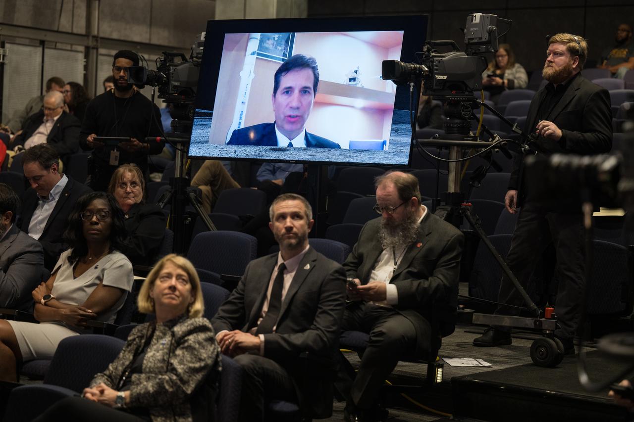 Blue Origin Human Landing System Program Manager, John Couluris, is seen on the monitor answering a question during an event announcing Blue Origin as the company selected to develop a sustainable human landing system for the Artemis V Moon mission, Friday, May 19, 2023 at the Mary W. Jackson NASA Headquarters building in Washington. The human landing system will take astronauts to and from Gateway in lunar orbit to the surface and back to the lunar space station as part of NASA’s return to the Moon for science, exploration, and inspiration. Photo Credit: (NASA/Aubrey Gemignani)