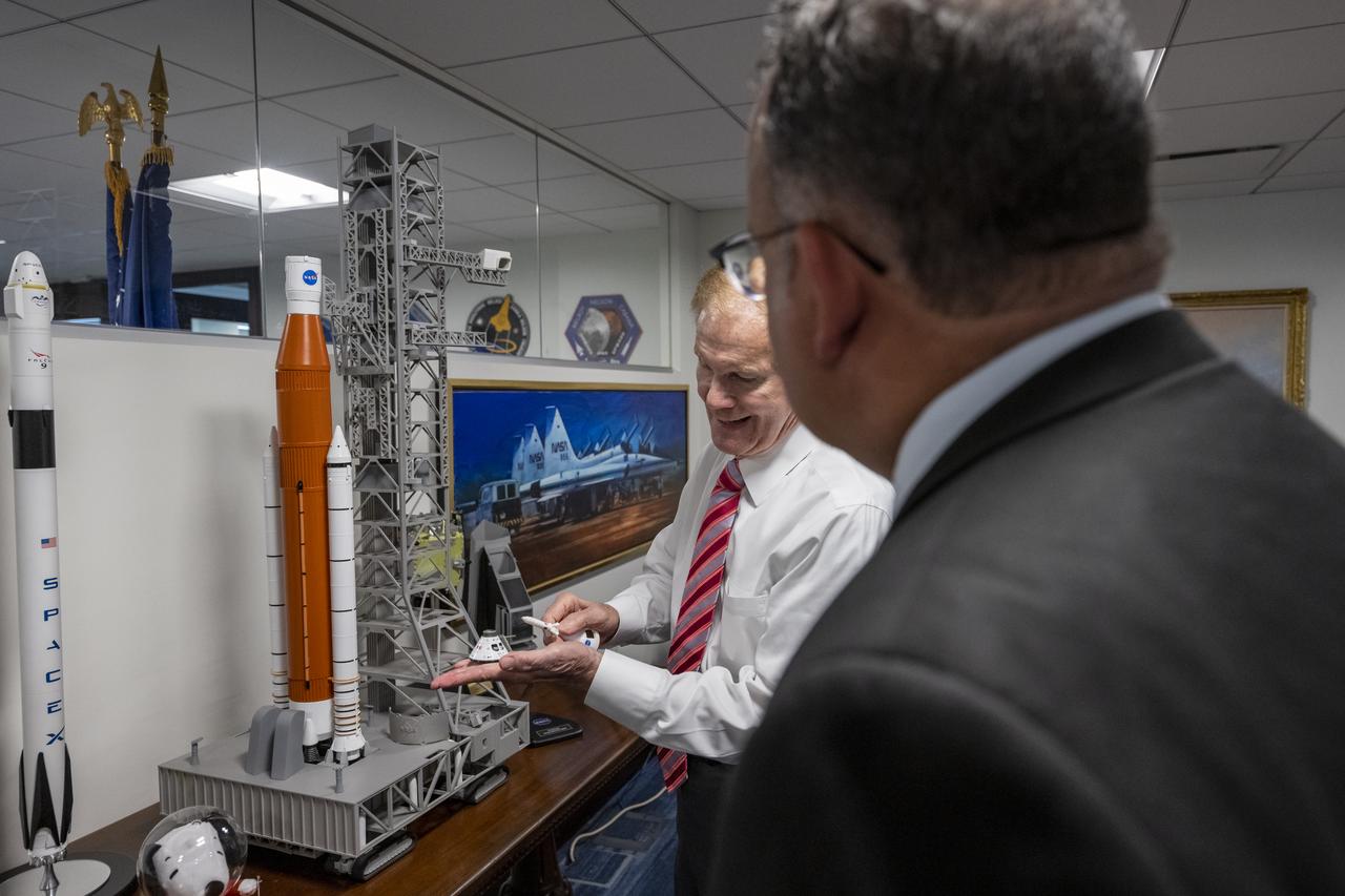 NASA Administrator Bill Nelson, left, shows Secretary of Education Miguel Cardona, right, a model of NASA’s Space Launch System (SLS) and Orion capsule prior to a memorandum of understanding (MOU) signing ceremony, Wednesday, May 24, 2023, at the Mary W. Jackson NASA Headquarters building in Washington.  The NASA and Department of Education MOU is focused on strengthening the collaboration between the two agencies, including efforts that advance STEM education across the nation. Photo Credit: (NASA/Keegan Barber)