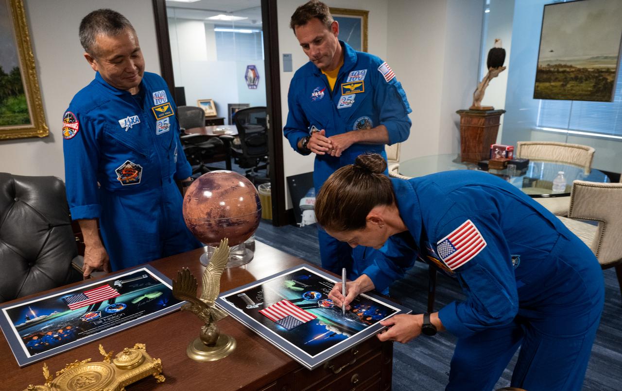 NASA’s SpaceX Crew-5 astronaut Nicole Mann of NASA signs a montage for NASA Deputy Administrator Pam Melroy as her NASA SpaceX Crew-5 crewmates Koichi Wakata of the Japan Aerospace Exploration Agency (JAXA) and Josh Cassada of NASA look on, Monday, June 5, 2023 at the Mary W. Jackson NASA Headquarters building in Washington. Mann, Cassada, and Wakata spent 157 days in space as part of Expedition 68 aboard the International Space Station. Photo Credit: (NASA/Joel Kowsky)