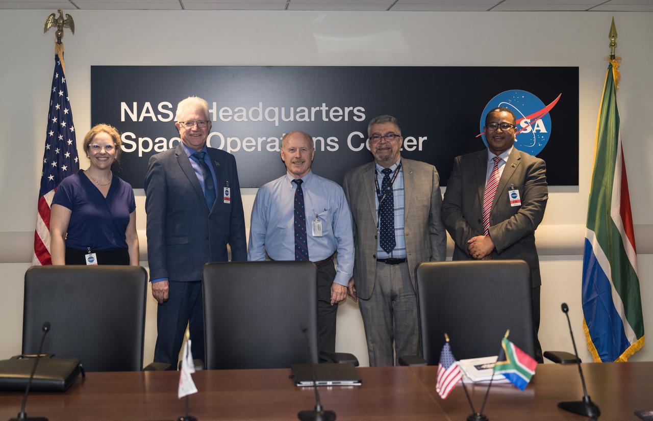 From left to right, Provincial Minister for Finance and Economic Opportunities of the Western Cape Government, Mireille Wenger, Premier of the Western Cape Government, Alan Winde, NASA Associate Administrator for the Space Operations Mission Directorate, Ken Bowersox, NASA Deputy Associate Administrator for Space Communications and Navigation, Badri Younes, and Director-General of the Western Cape Government, Dr. Harry Malila, pose for a photo in the Space Operations Center during a meeting with NASA and Western Cape Government representatives, to discuss the path forward for development of an antenna for the Lunar Exploration Ground Sites (LEGS) mission in Matjiesfontein, South Africa, and other opportunities, Tuesday, June 13, 2023, at the Mary W. Jackson NASA Headquarters building in Washington. Photo Credit: (NASA/Aubrey Gemignani)