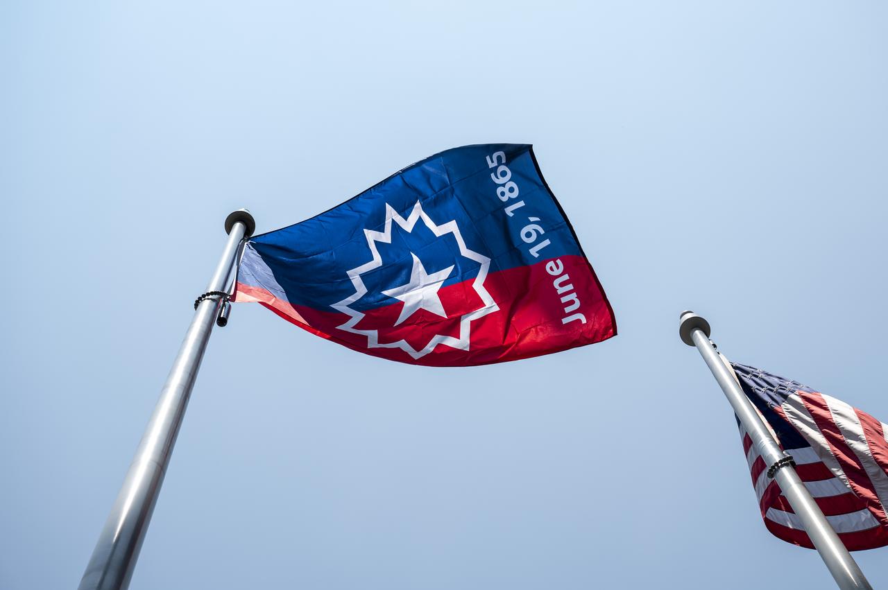 The Juneteenth flag is seen waving in the wind during a flag raising ceremony in recognition and celebration of Juneteenth, Thursday, June 15, 2023, at the Mary W. Jackson NASA Headquarters building in Washington. Photo Credit: (NASA/Keegan Barber)