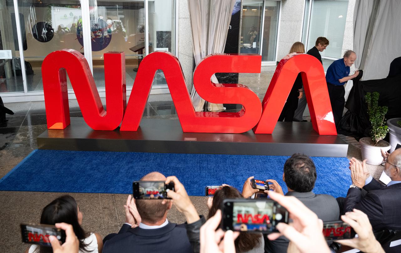 The NASA Worm Logo sign is unveiled before the ribbon cutting ceremony to open NASA’s Earth Information Center, Wednesday, June 21, 2023, at the Mary W. Jackson NASA Headquarters building in Washington. The Earth Information Center is new immersive experience that combines live data sets with cutting-edge data visualization and storytelling to allow visitors to see how our planet is changing.  Photo Credit: (NASA/Joel Kowsky)
